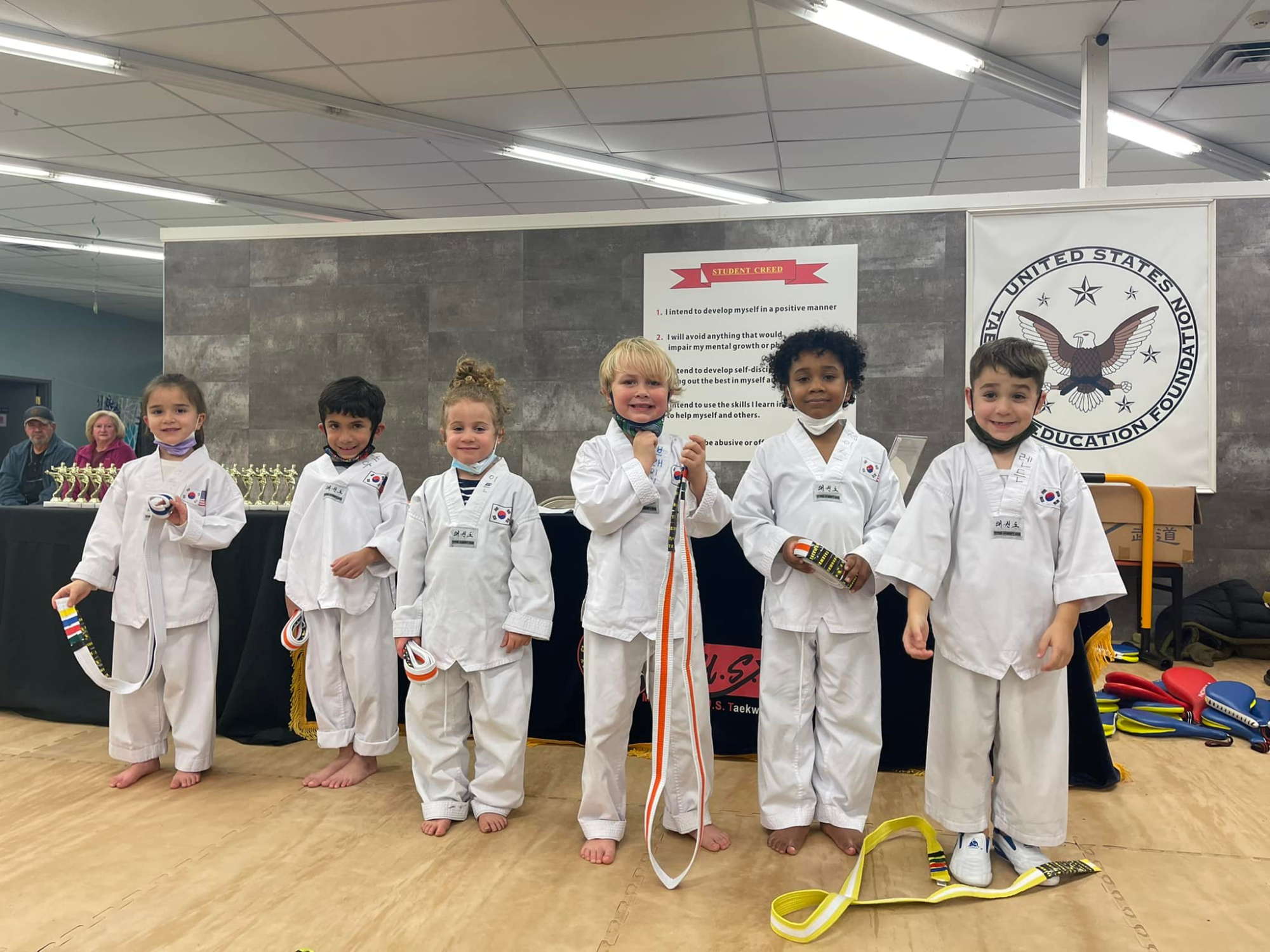 a group of kids in karate uniforms