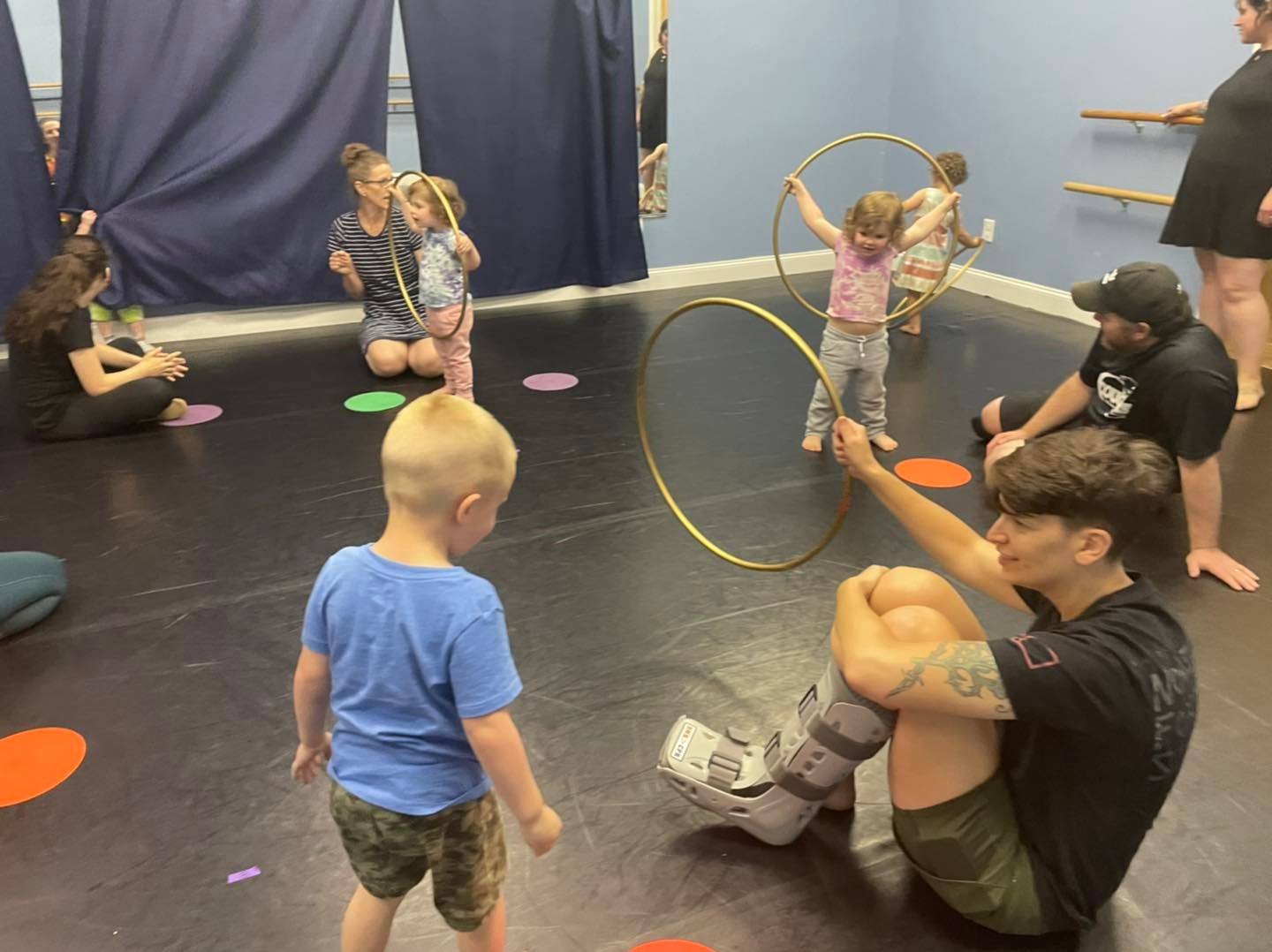 a group of people playing with a hula hoop