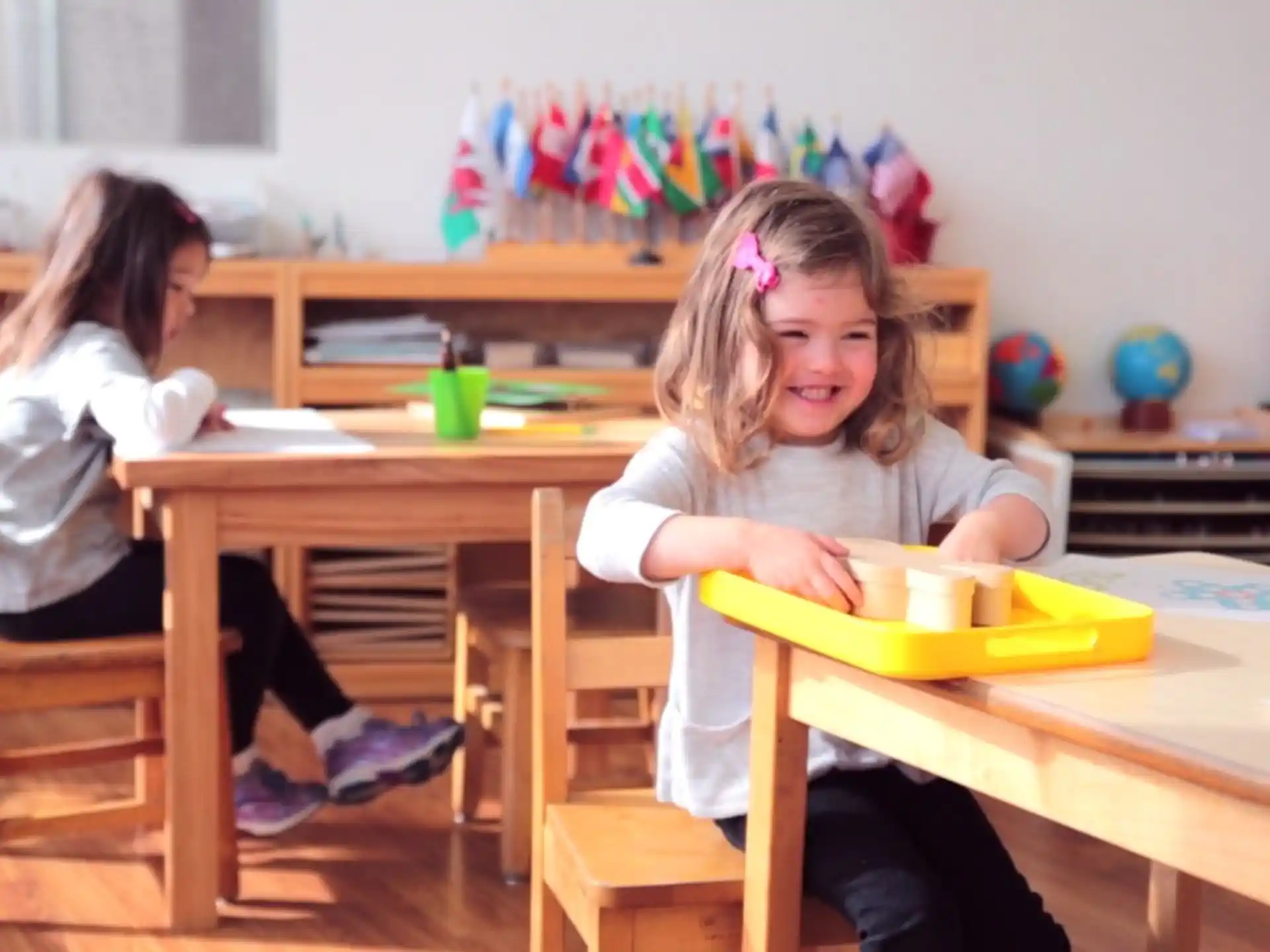 a few young girls sitting at a table