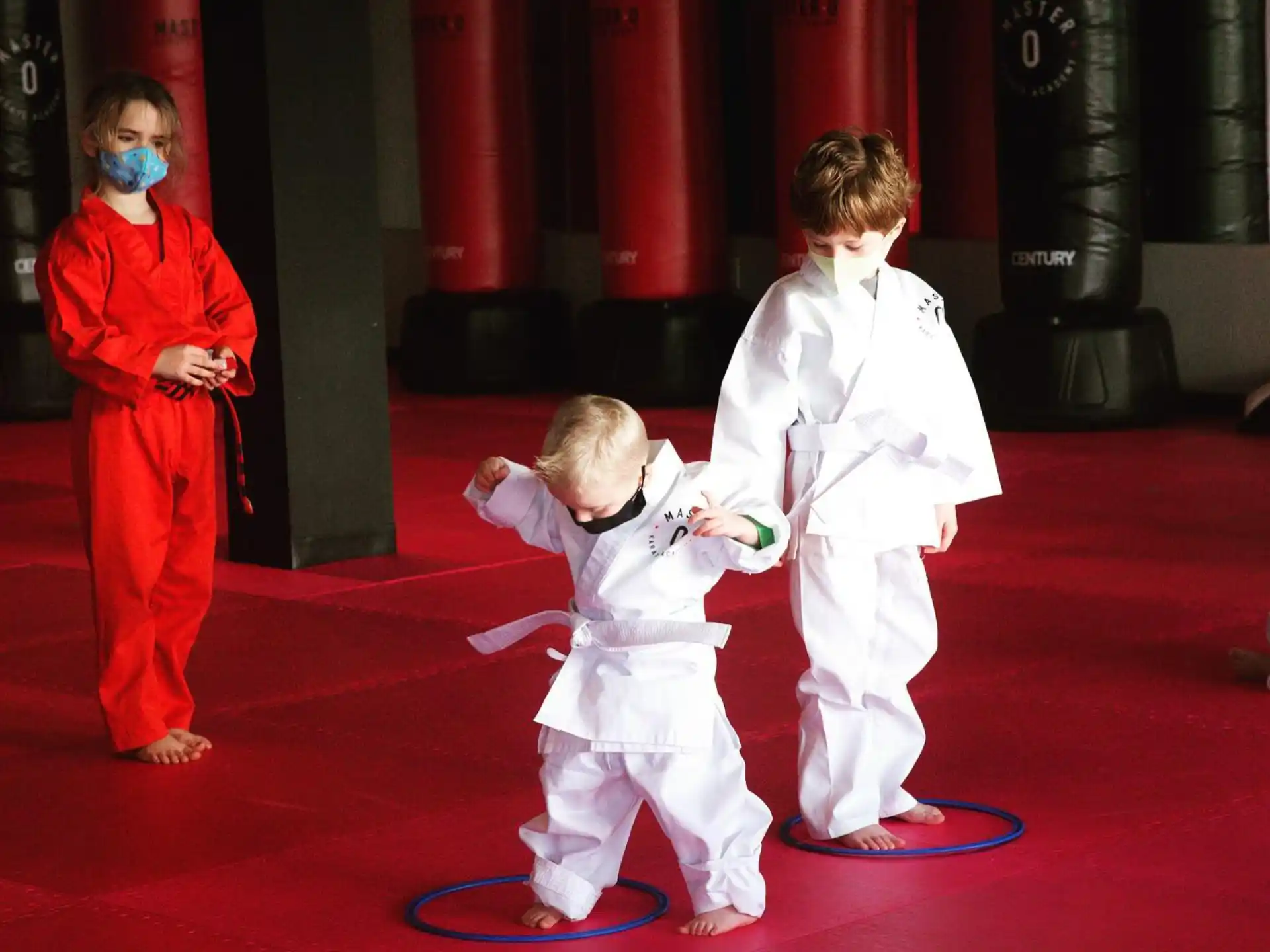 a group of kids wearing white suits and masks