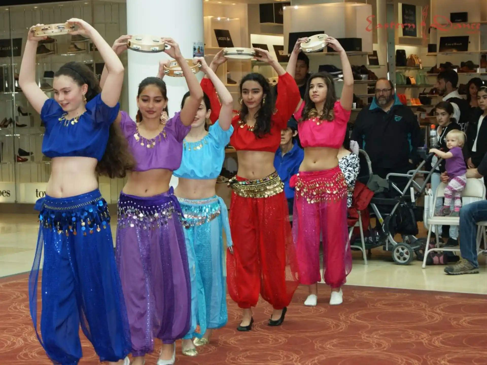 a group of women in colorful dresses