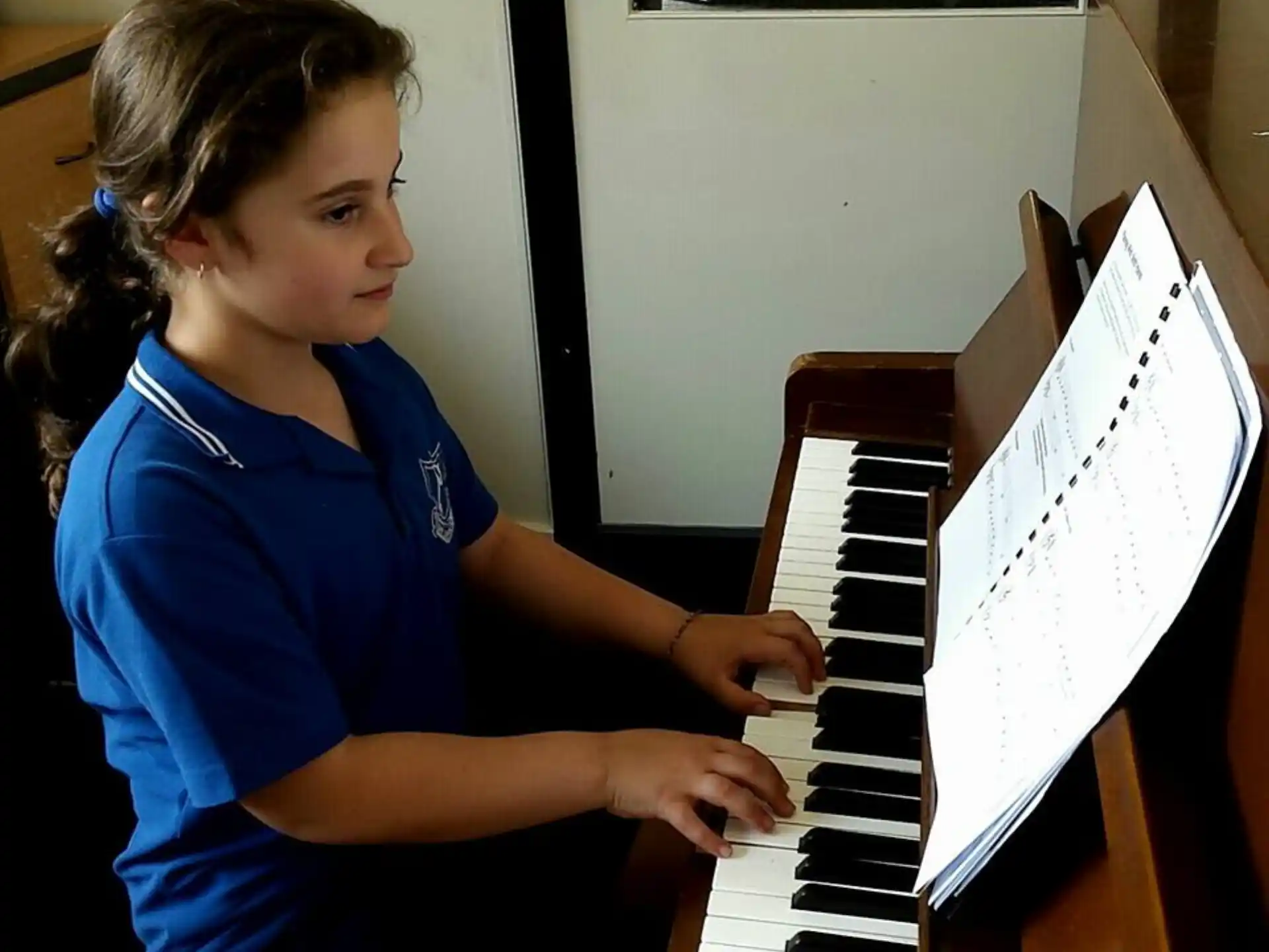 a girl playing a piano