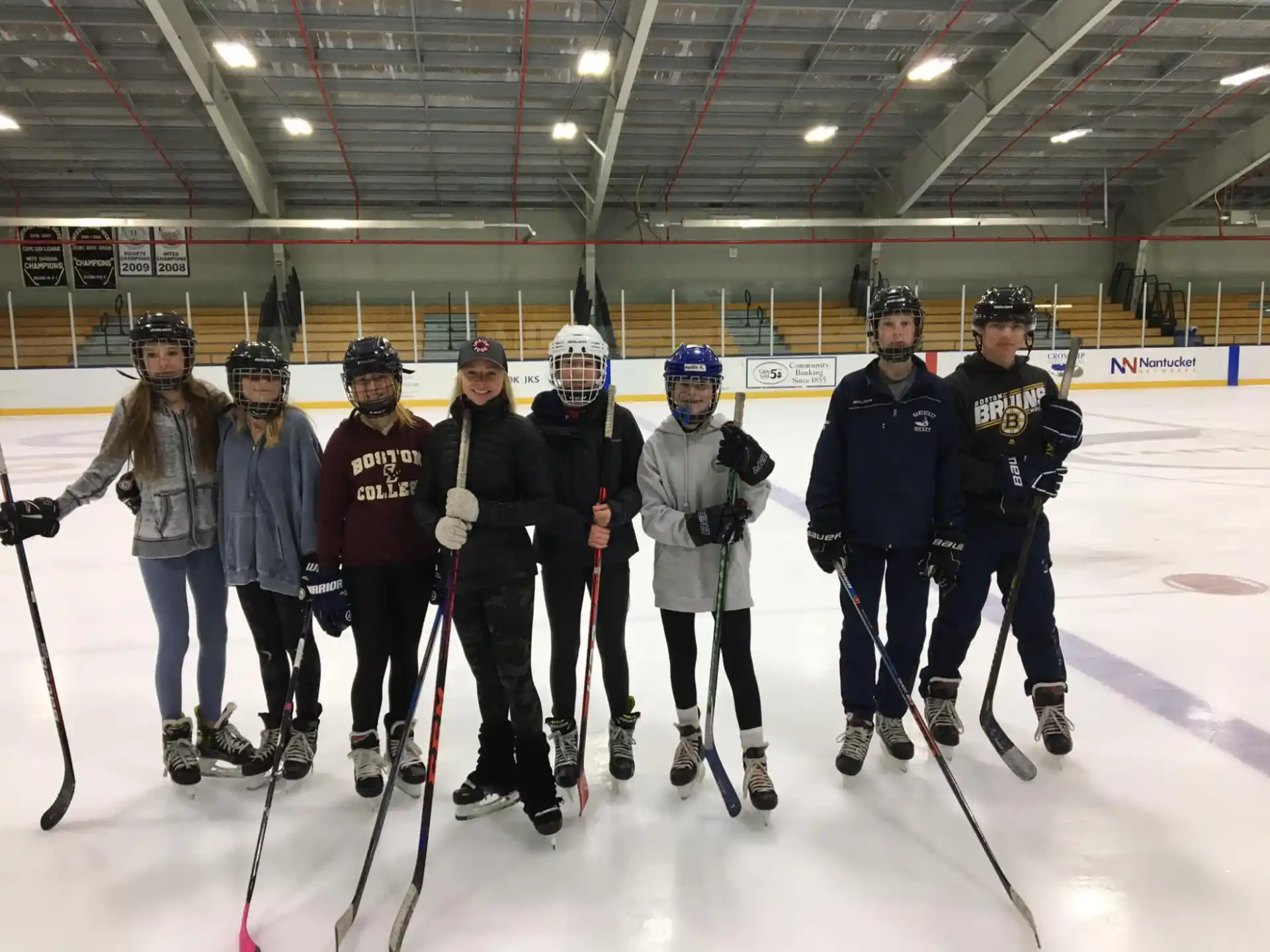 a group of people posing for a photo on an ice rink