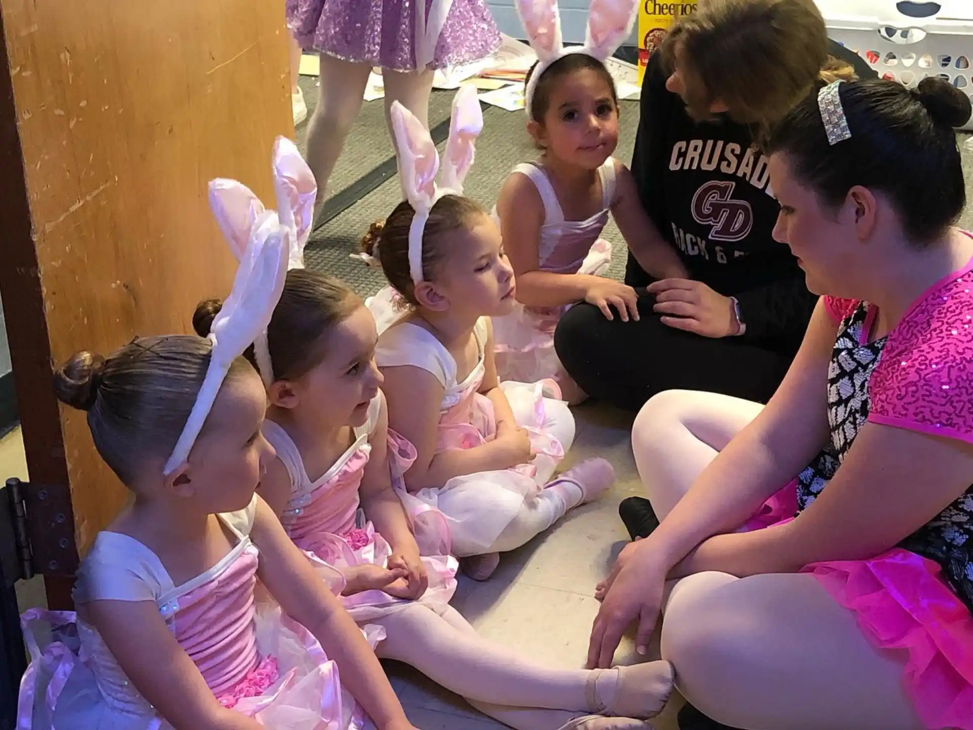 a group of children sitting on the ground