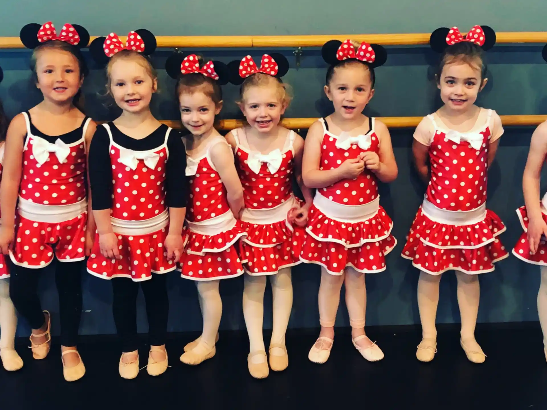 a group of girls in red and white dresses