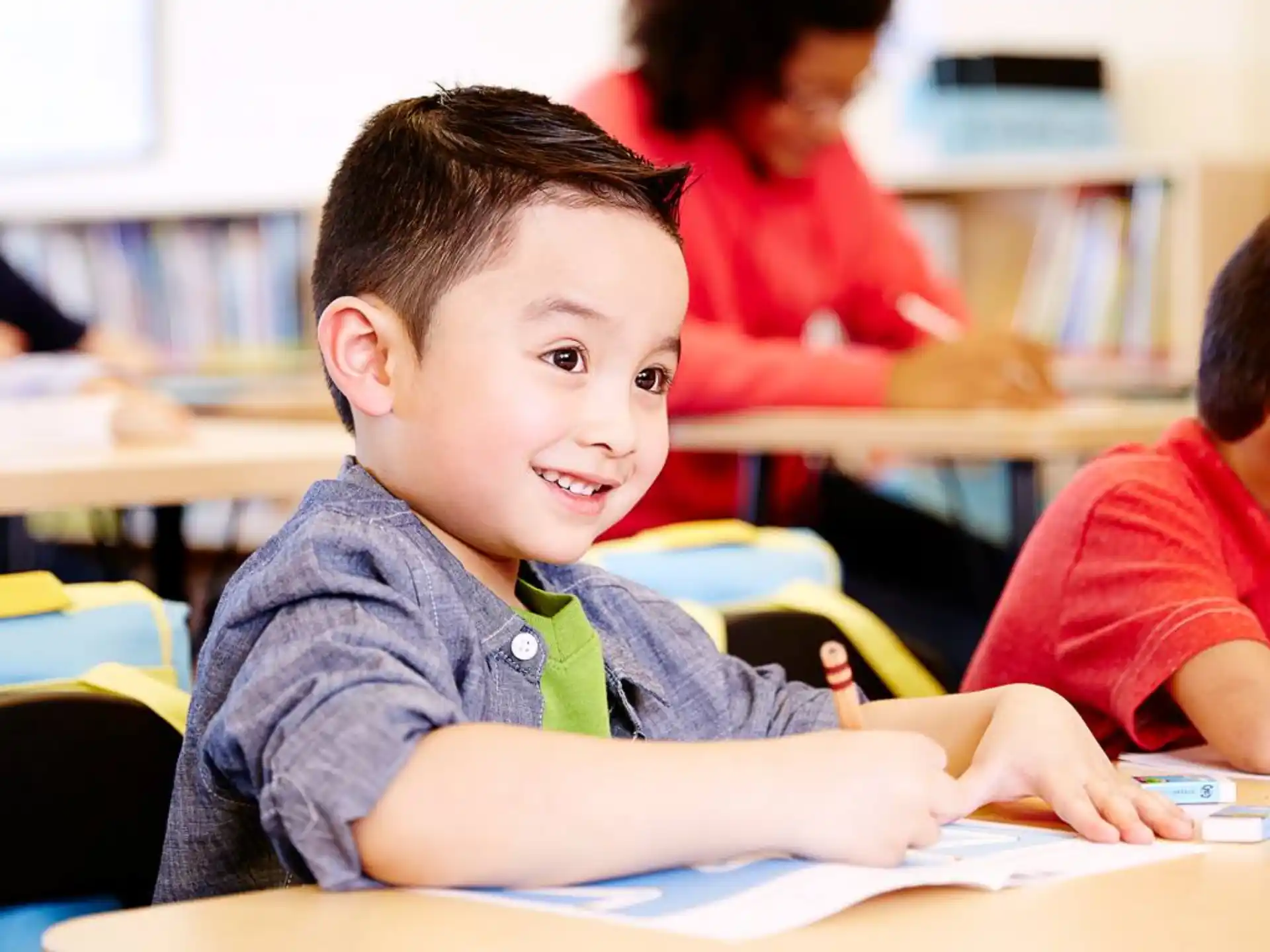 a boy sitting at a desk
