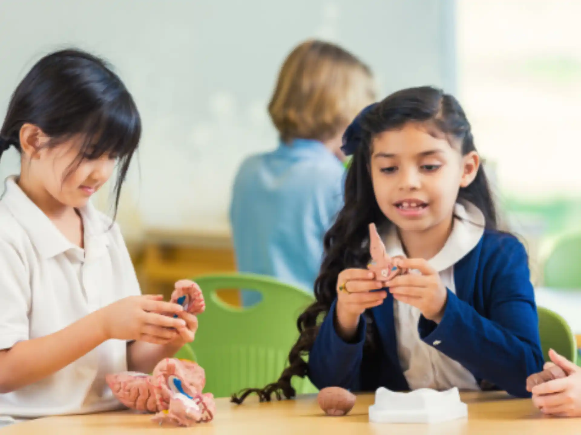 a few young girls sitting at a table