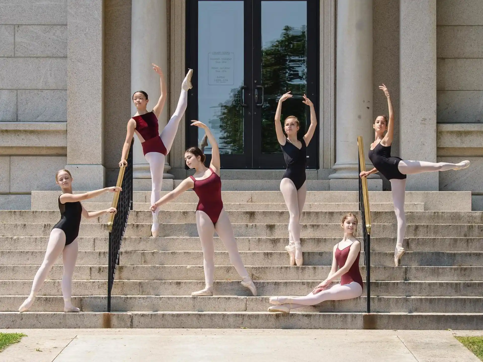 a group of women posing on stairs