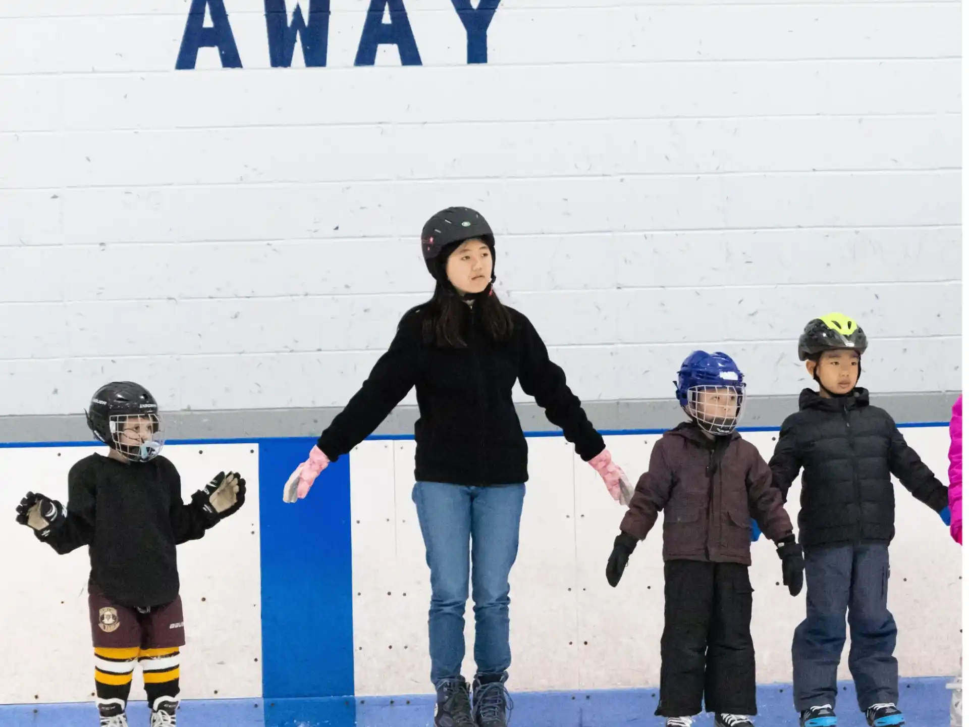 a man and several kids on ice
