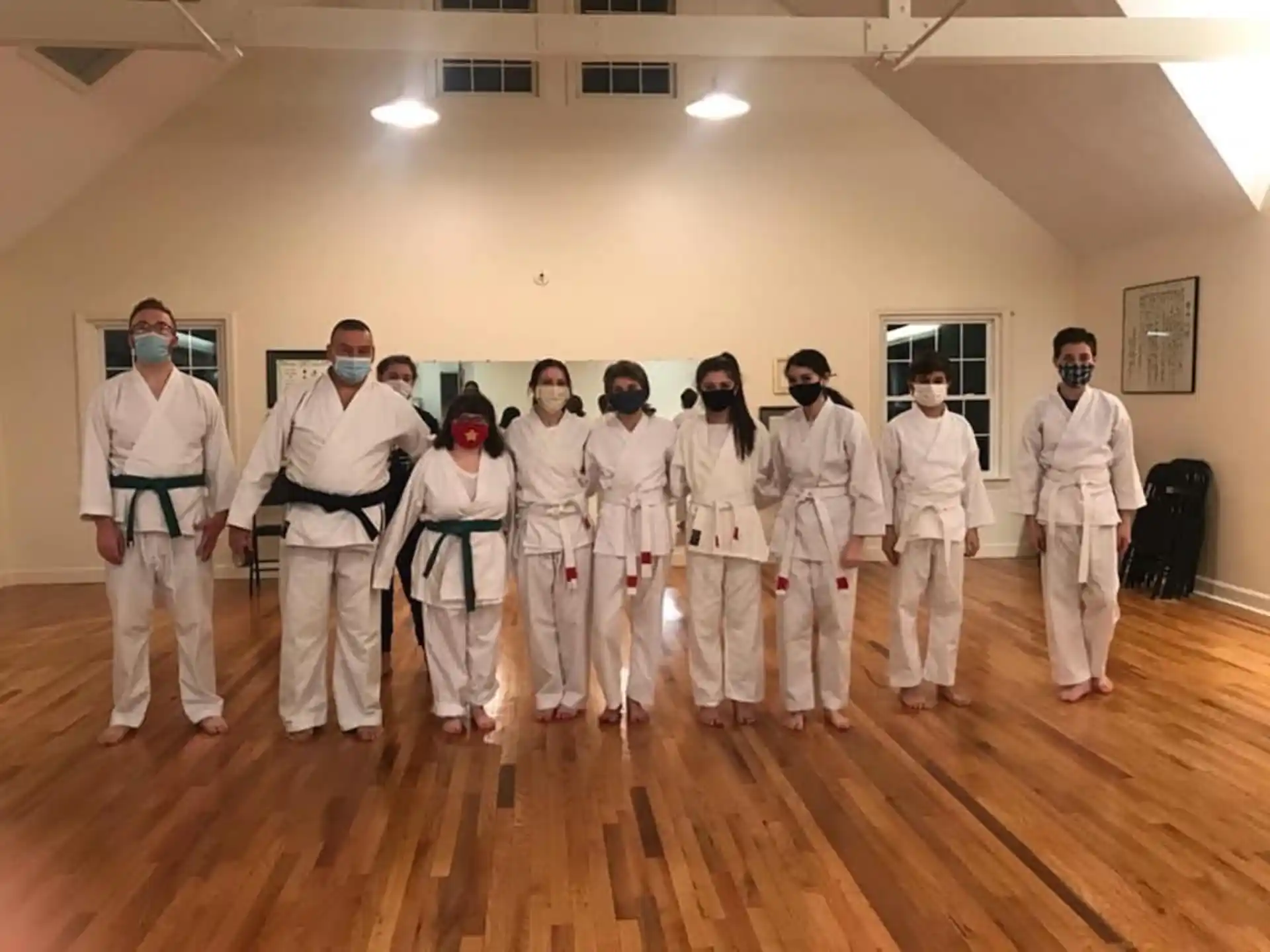 a group of people in white karate uniforms