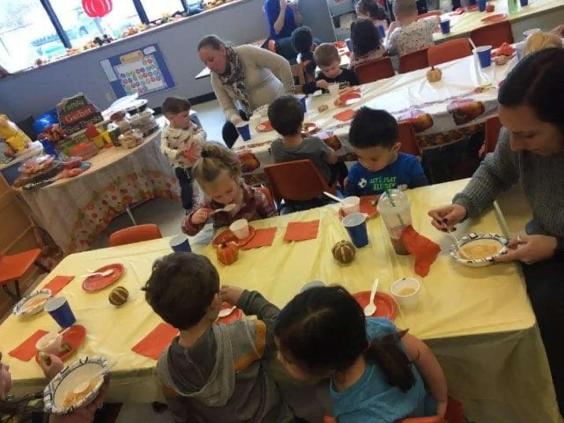 a group of children eating at a table
