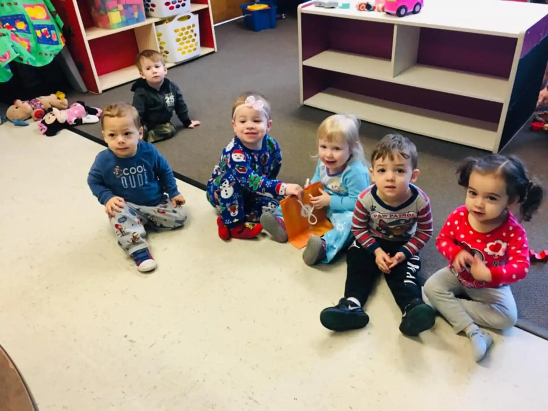 a group of children sitting on the floor