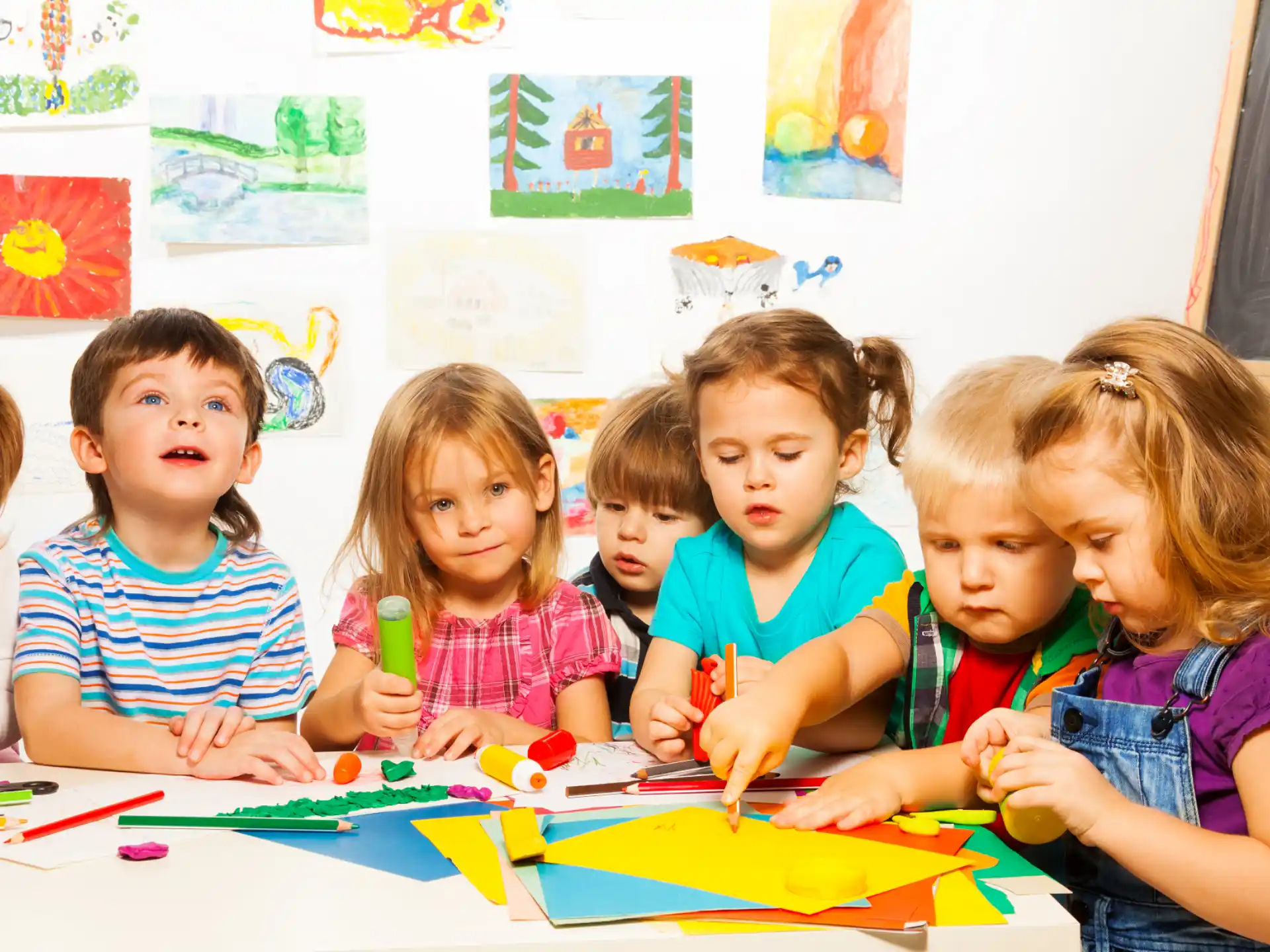a group of children sitting at a table
