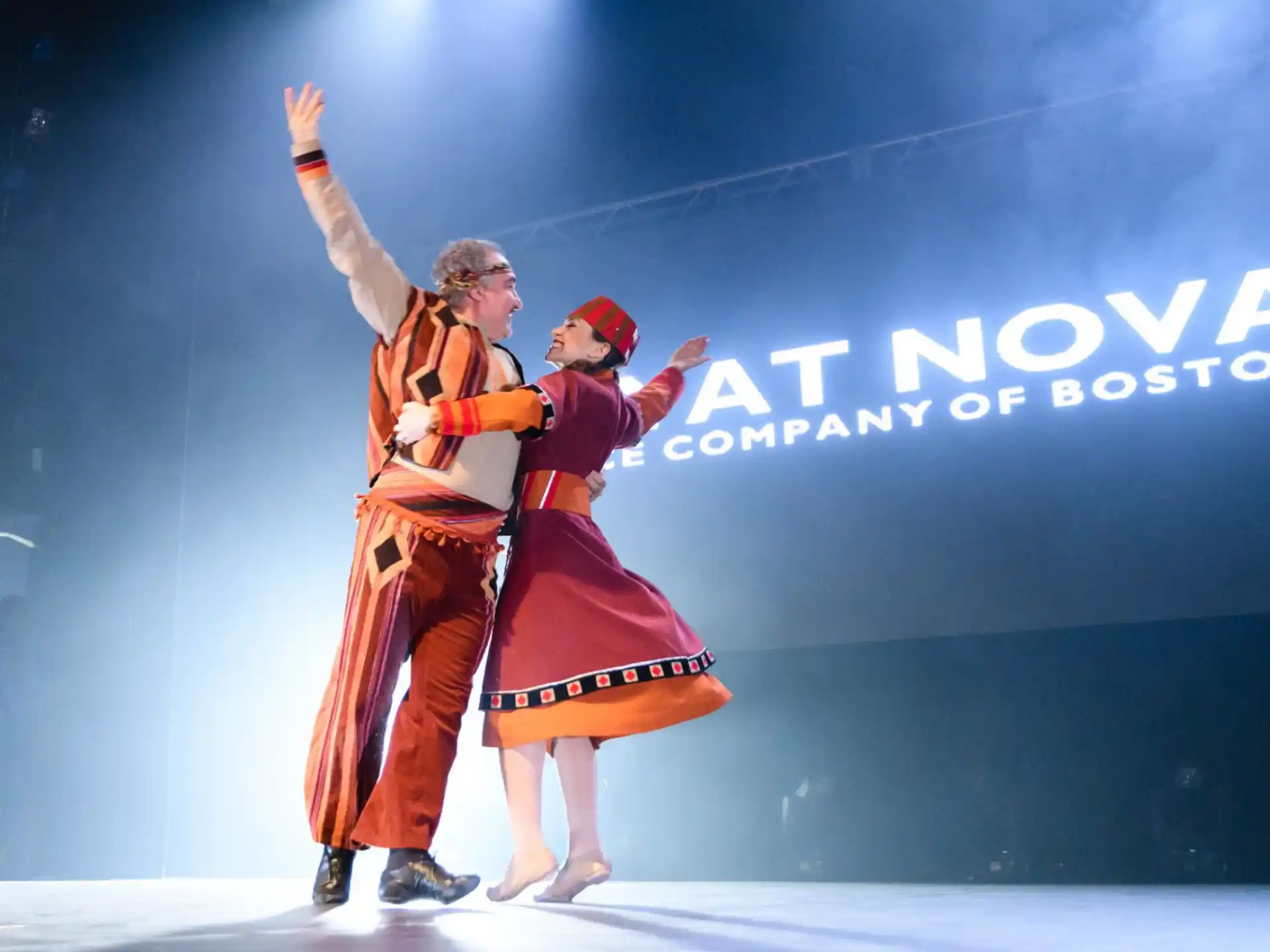 a man and woman dancing on a stage