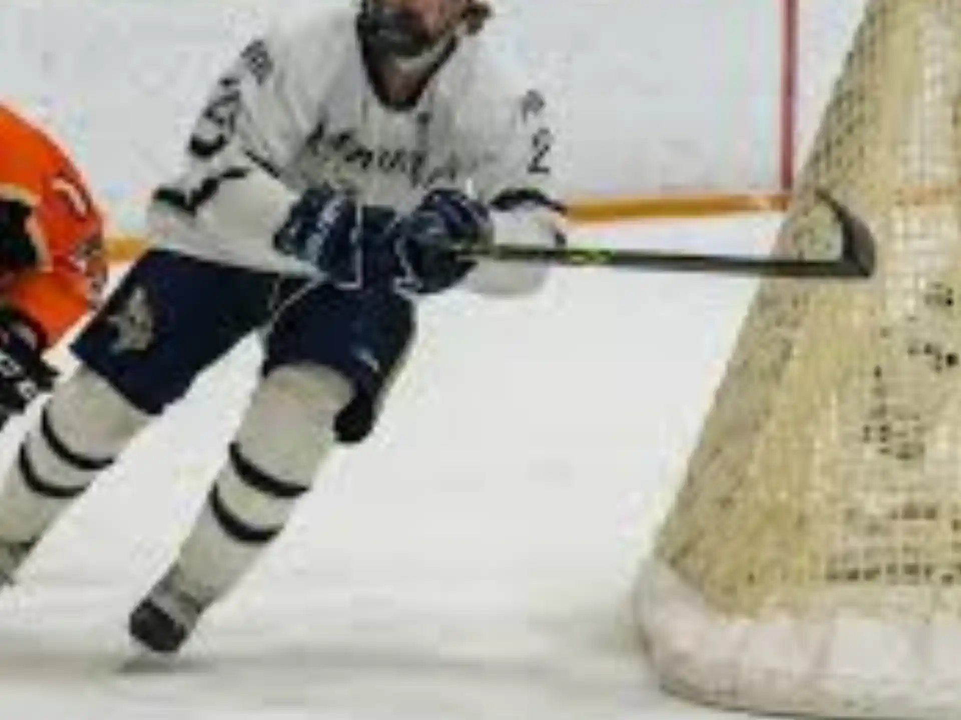 a hockey player in a white uniform