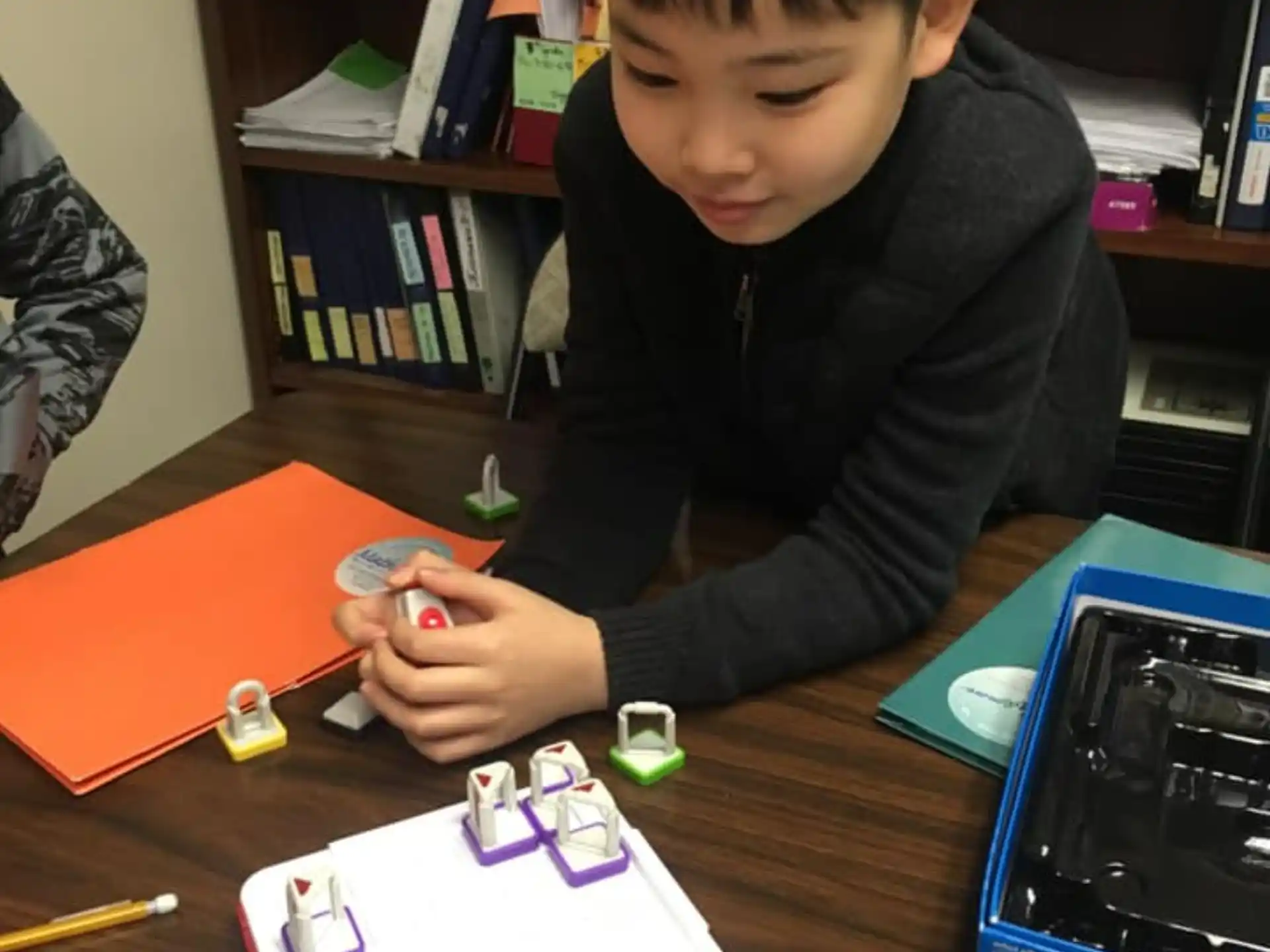 a boy playing with a toy