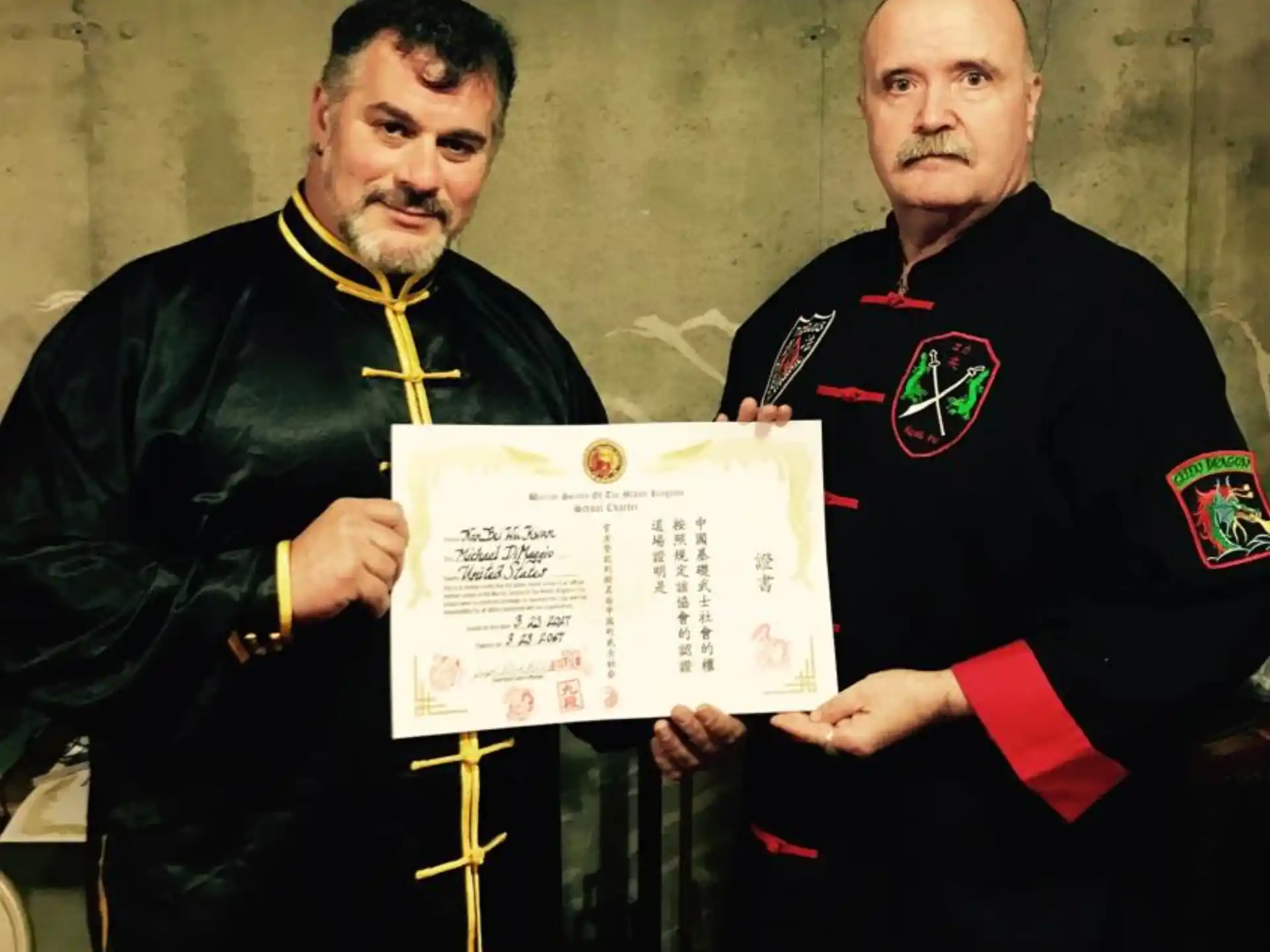 a couple of men holding a certificate