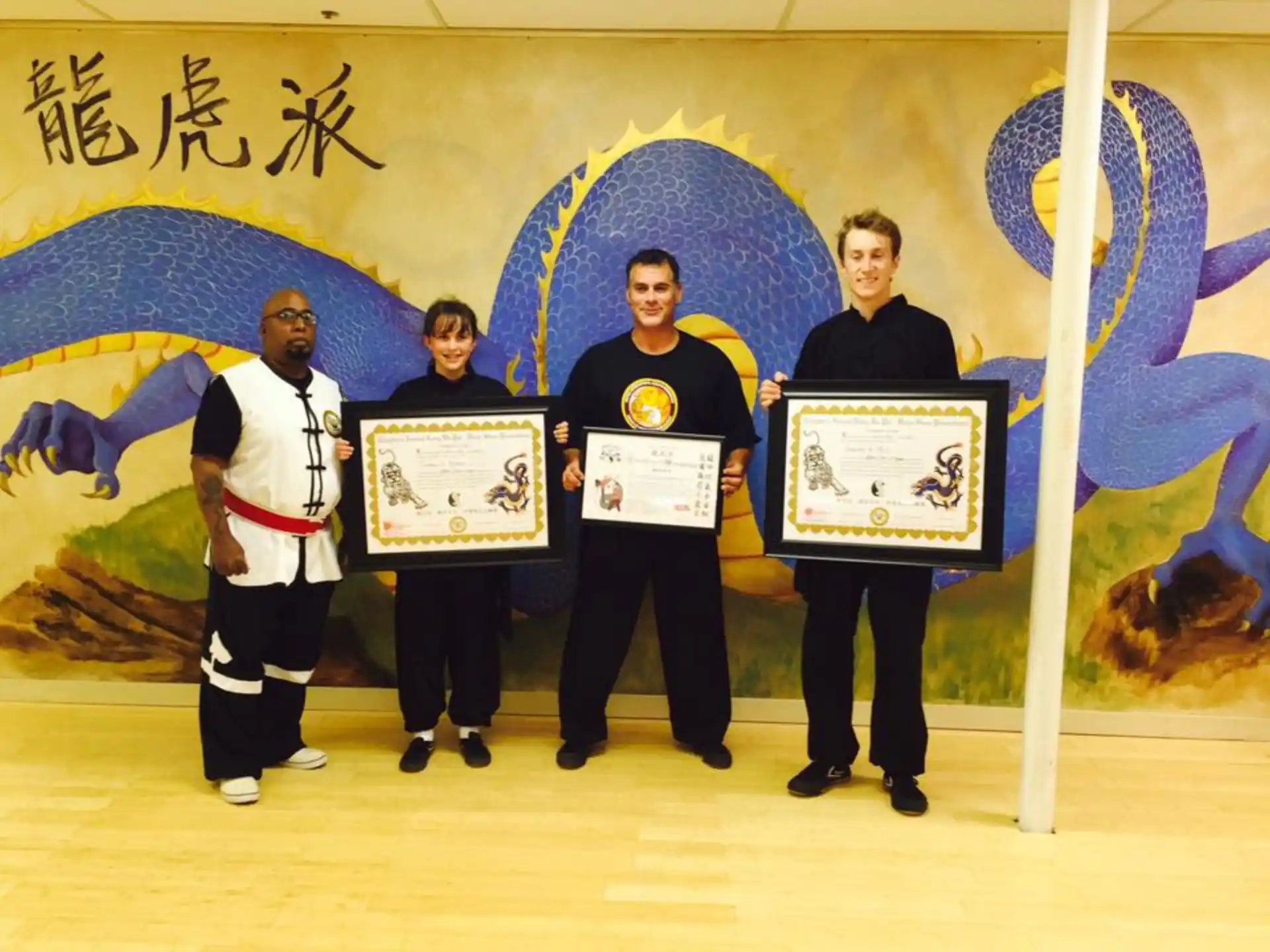 a group of people holding certificates
