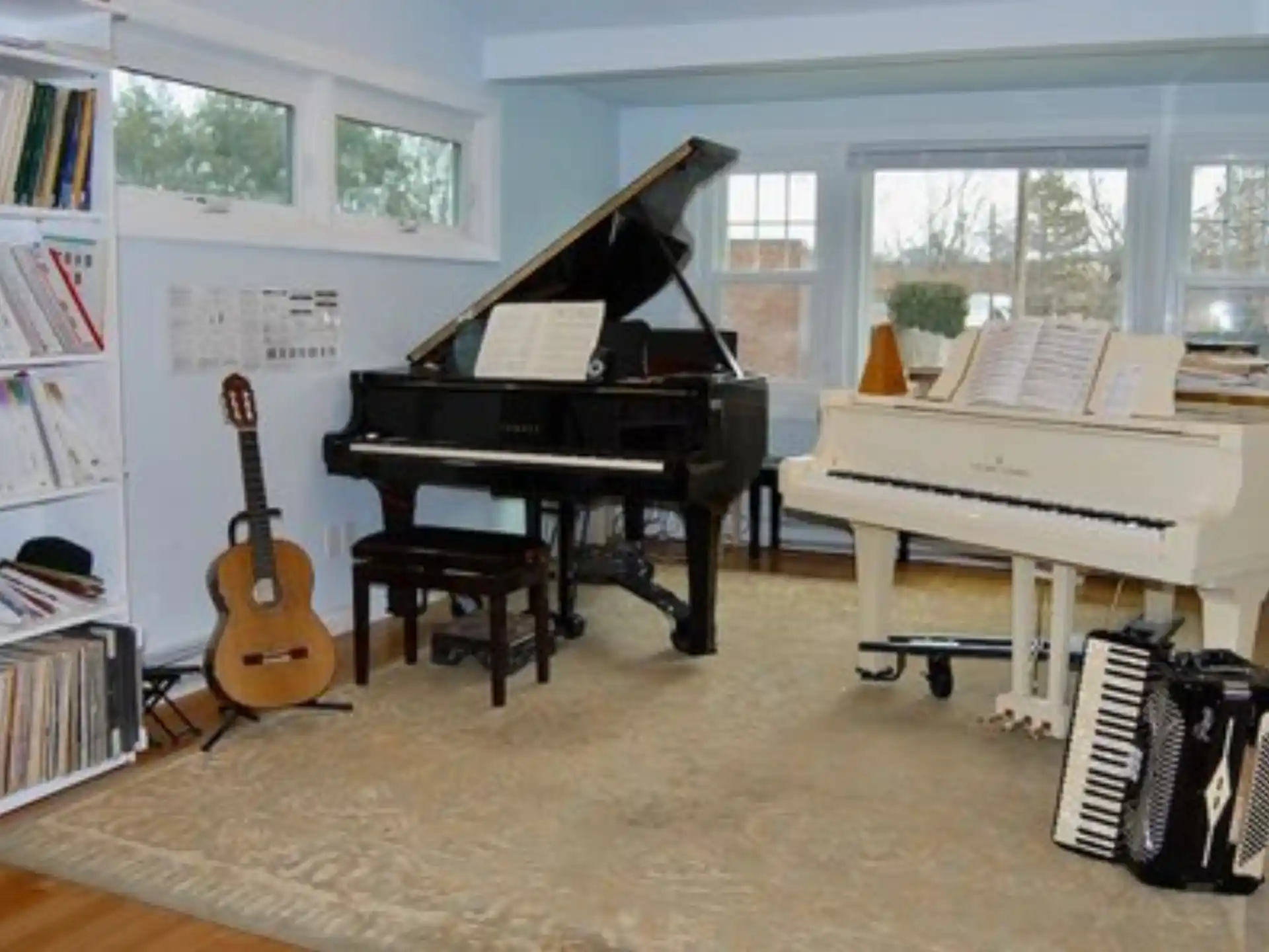 a room with a piano and bookshelves