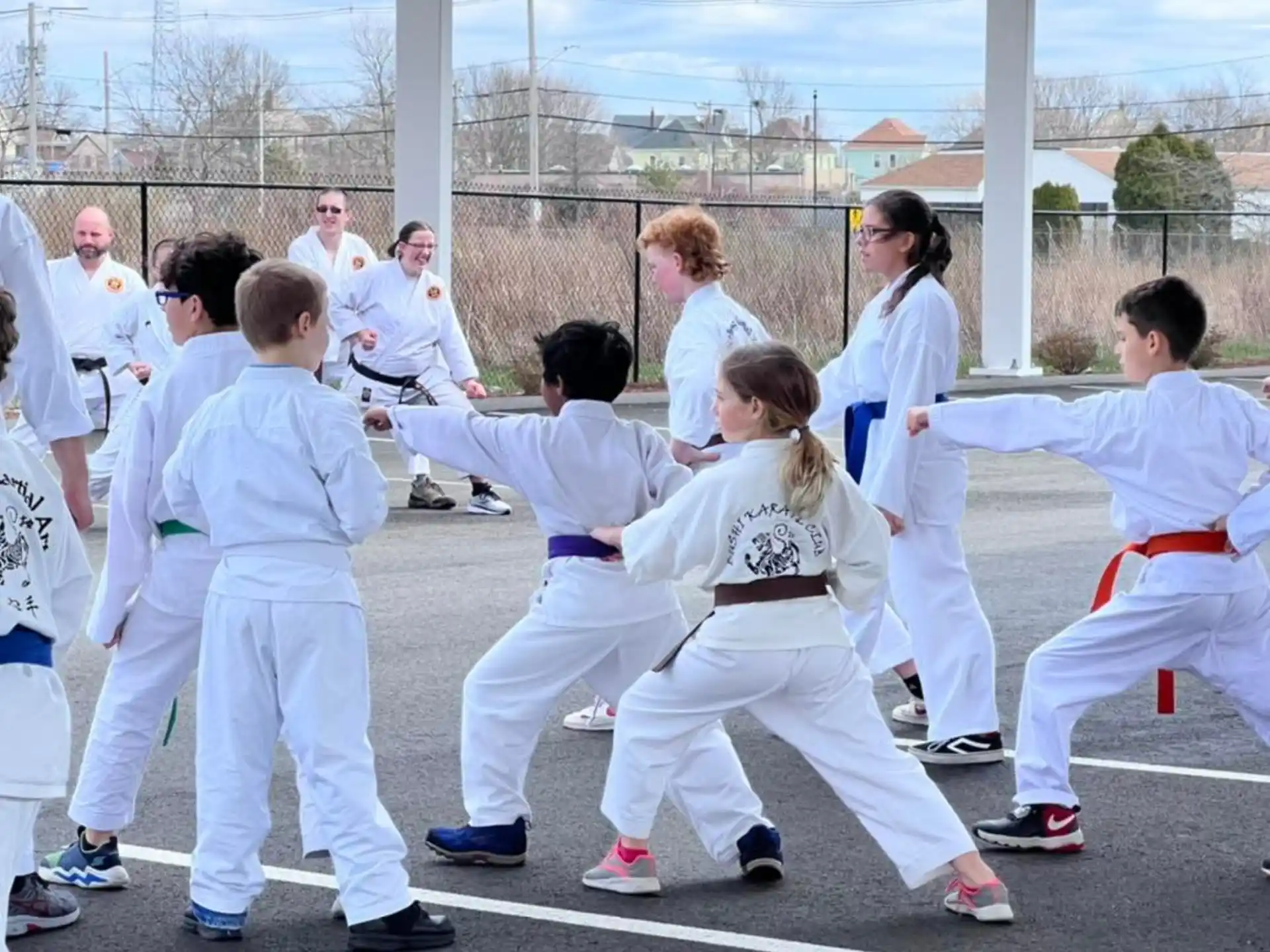 a group of people in white karate uniforms