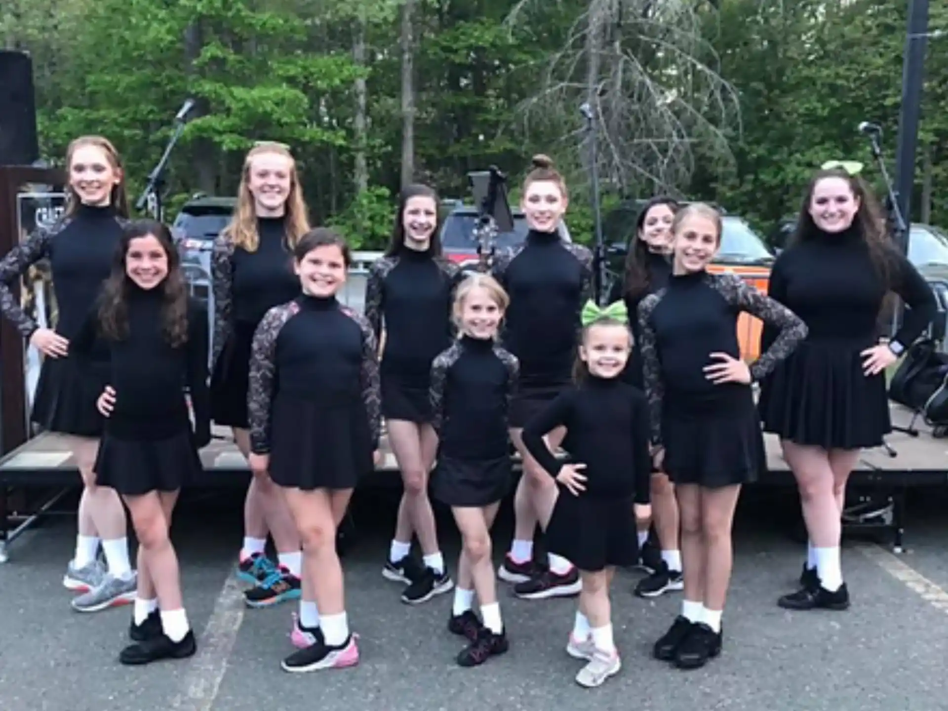 a group of girls in black dresses
