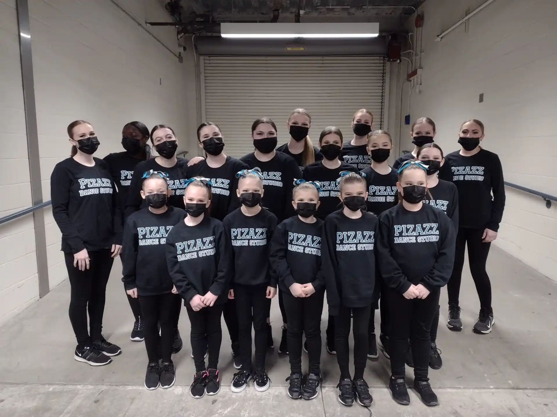 a group of people in black shirts