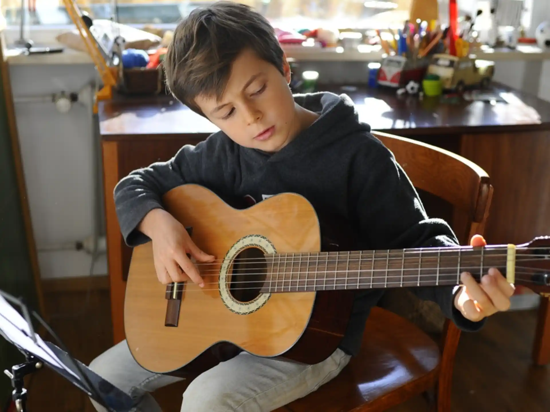 a boy playing a guitar