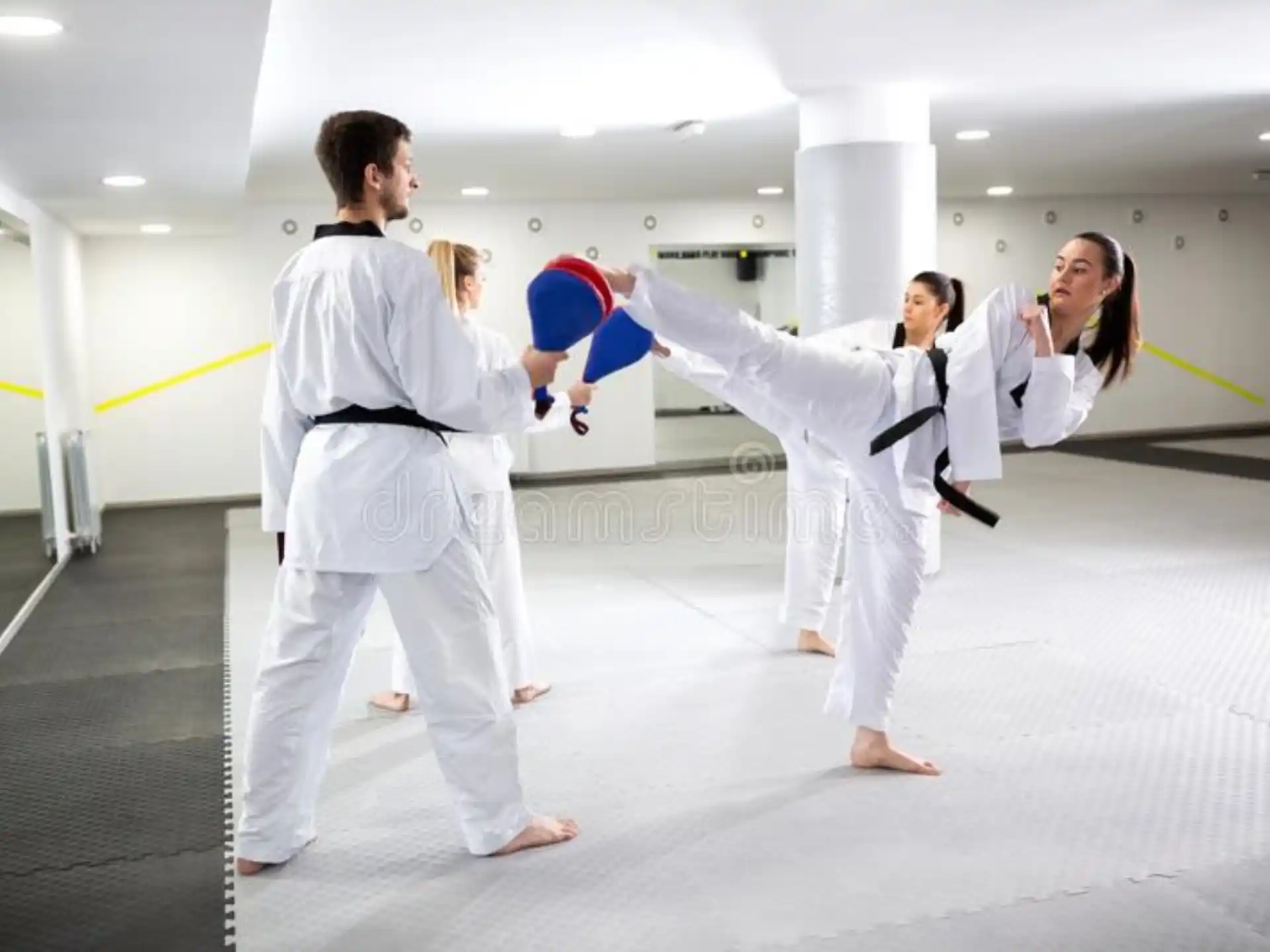 a group of people in white karate uniforms