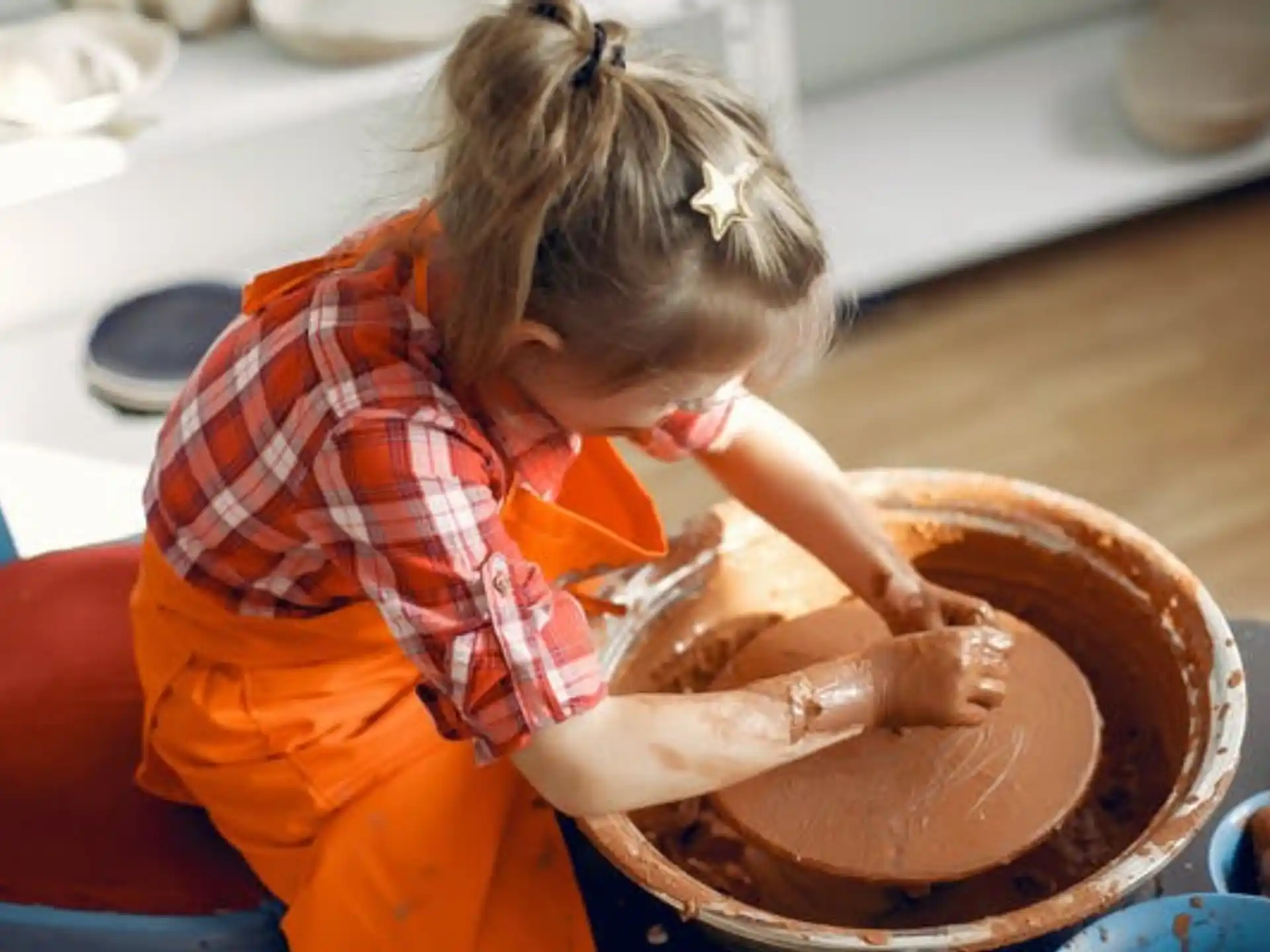 a little girl washing a chicken