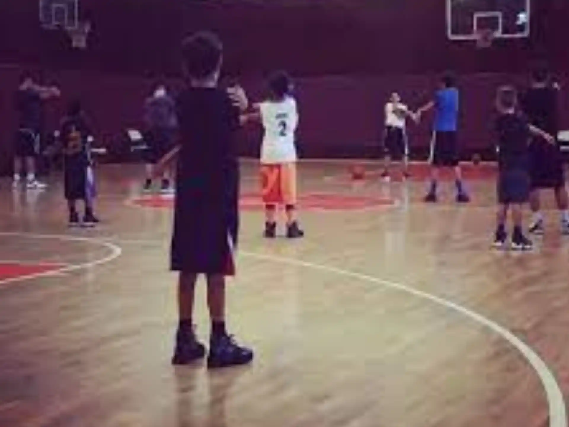 a group of people playing basketball