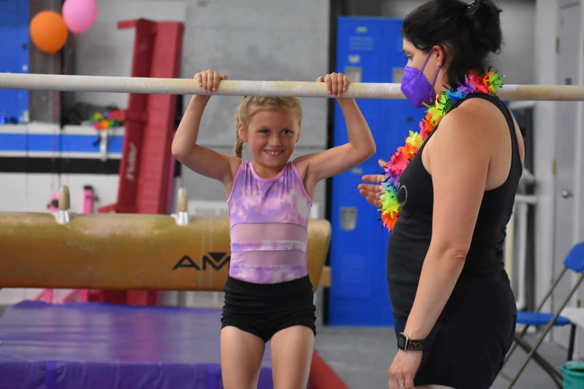 a woman lifting a girl up