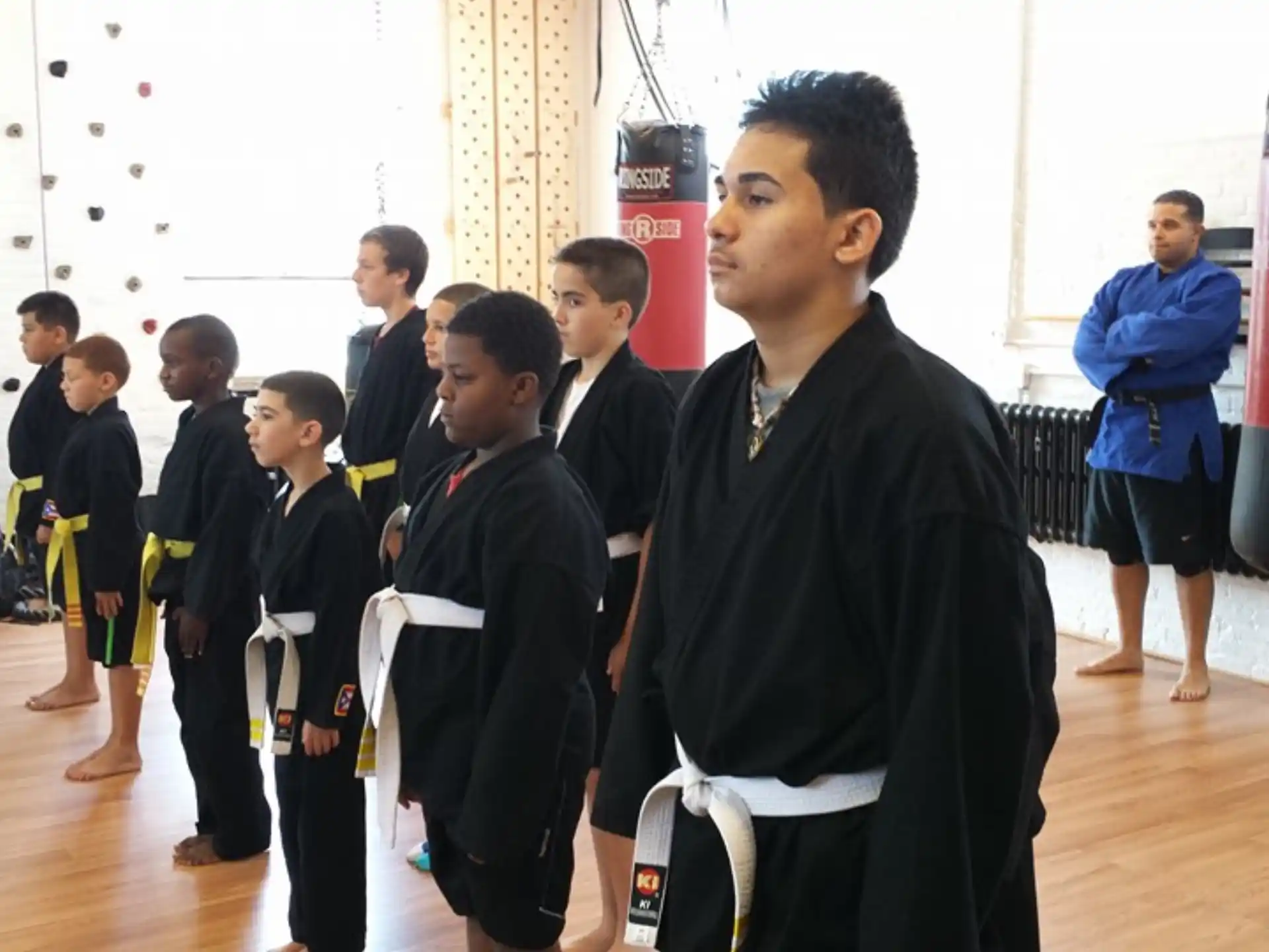 a person standing in front of a group of children in a room