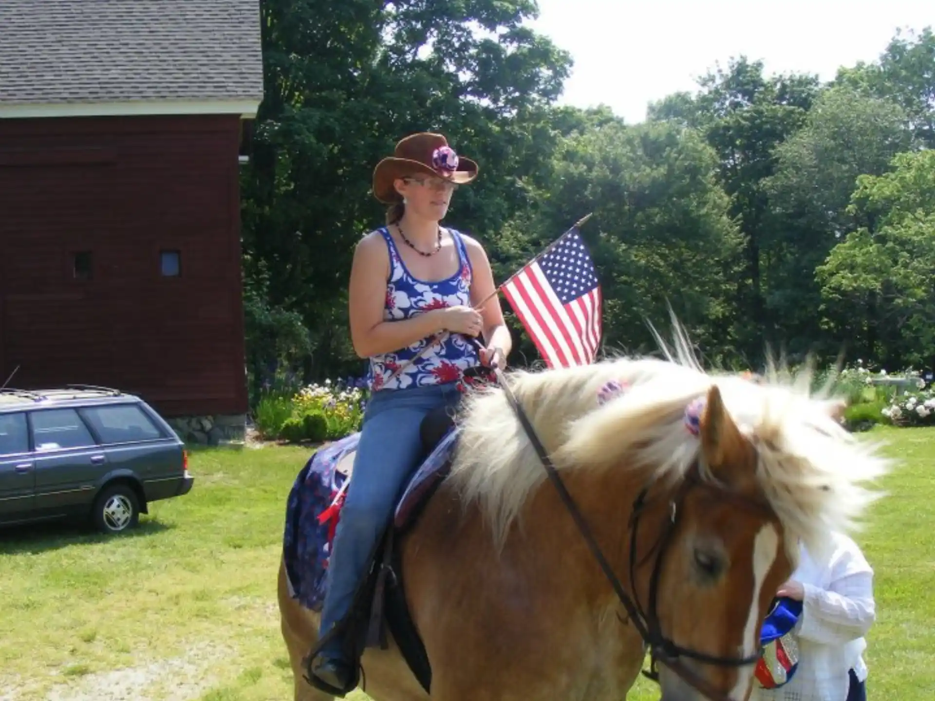 a person riding a horse with a child on the back