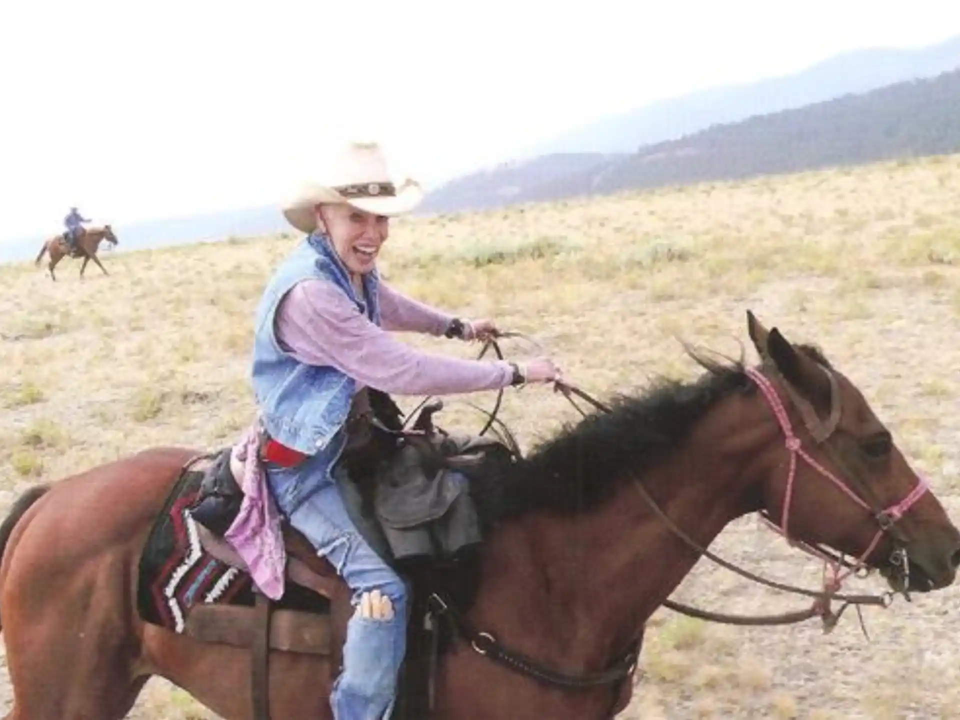 a woman riding a horse