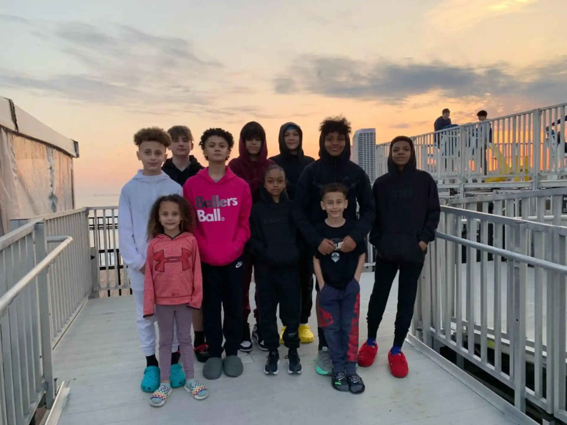 a group of people posing for a photo on a bridge