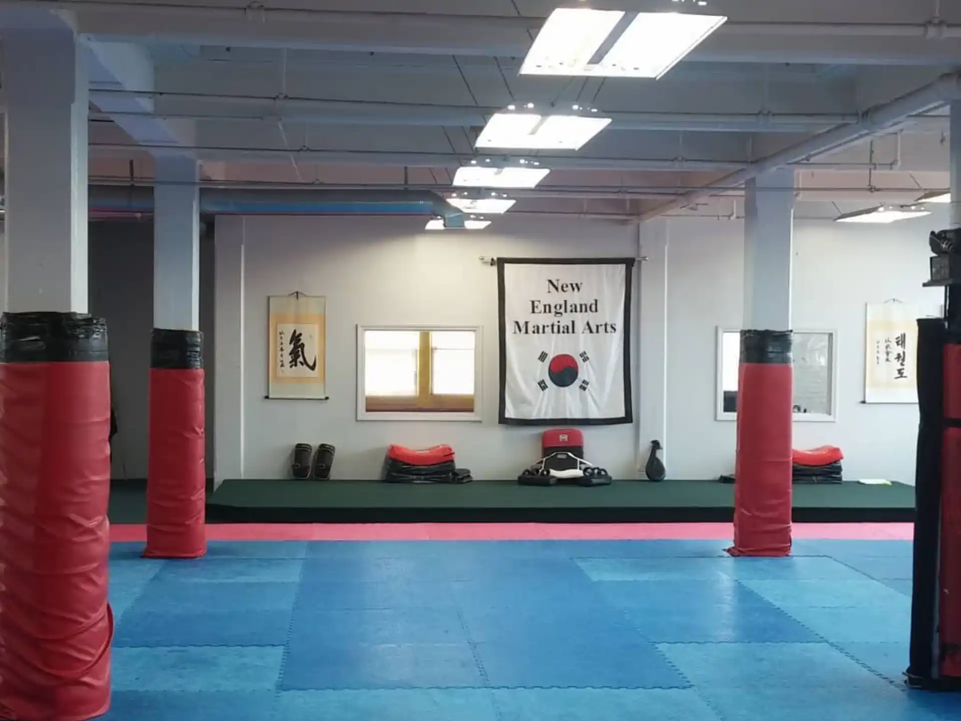 a room with a sign and red pillars