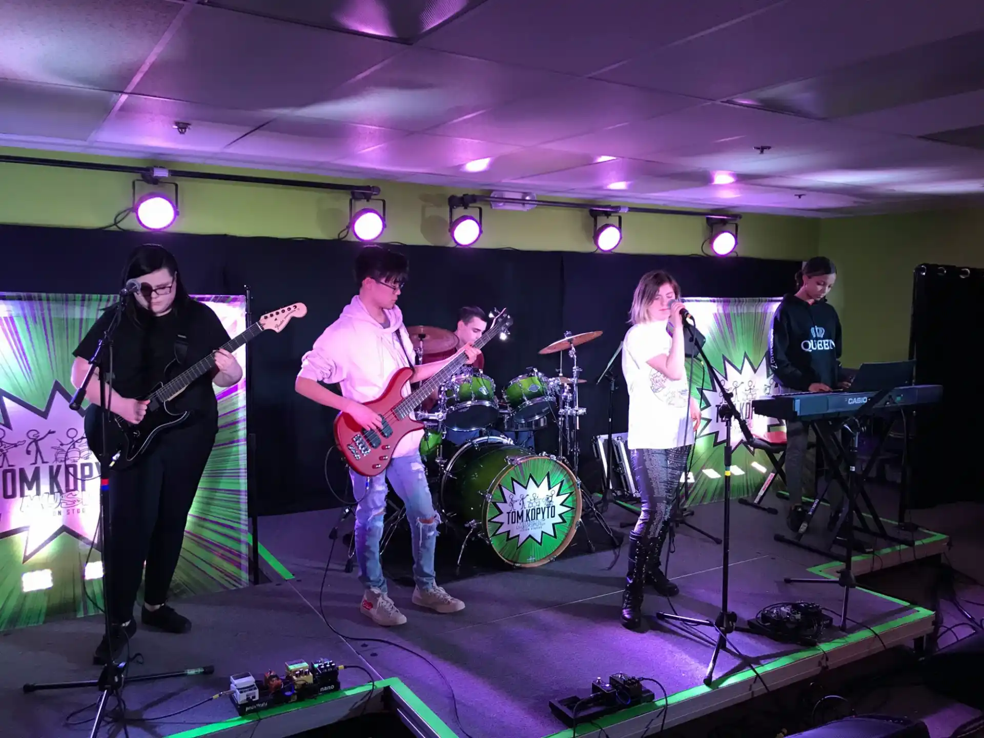 a group of people playing instruments on a stage