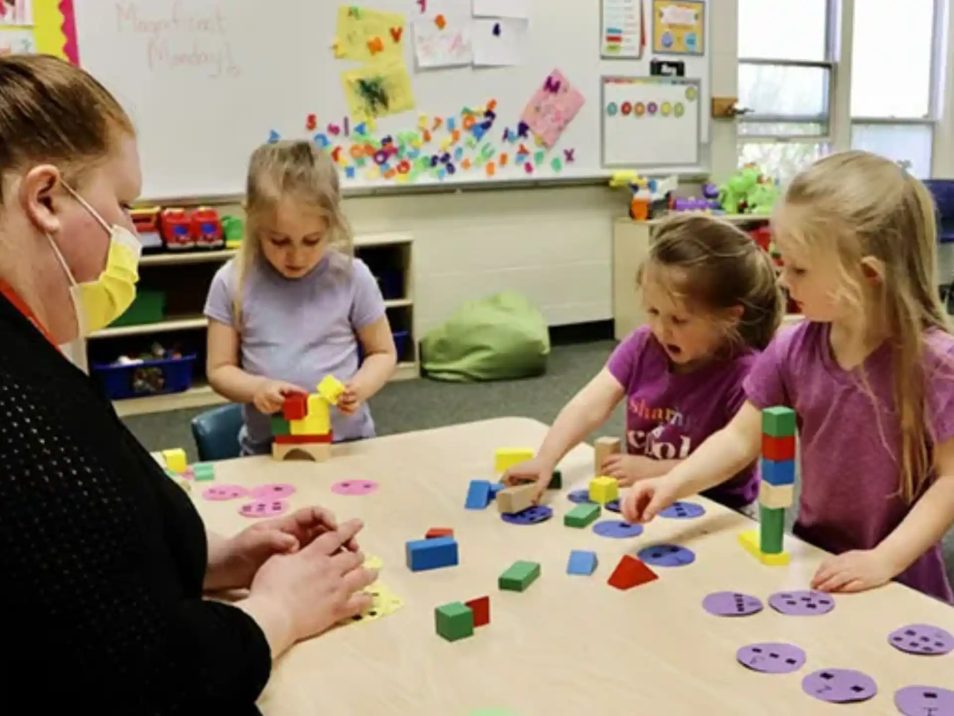 a person and several children playing with toys
