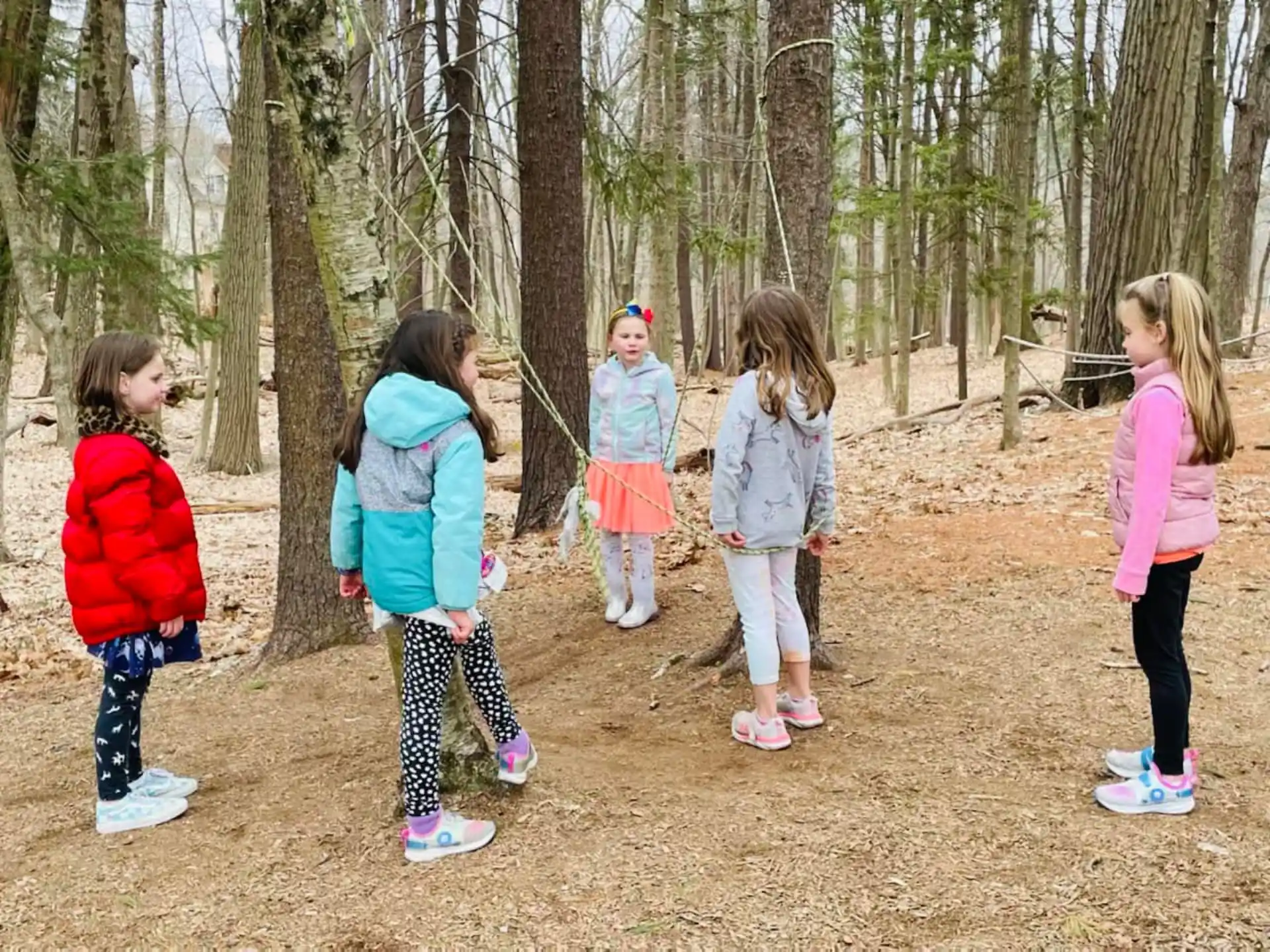 a group of children standing in a forest
