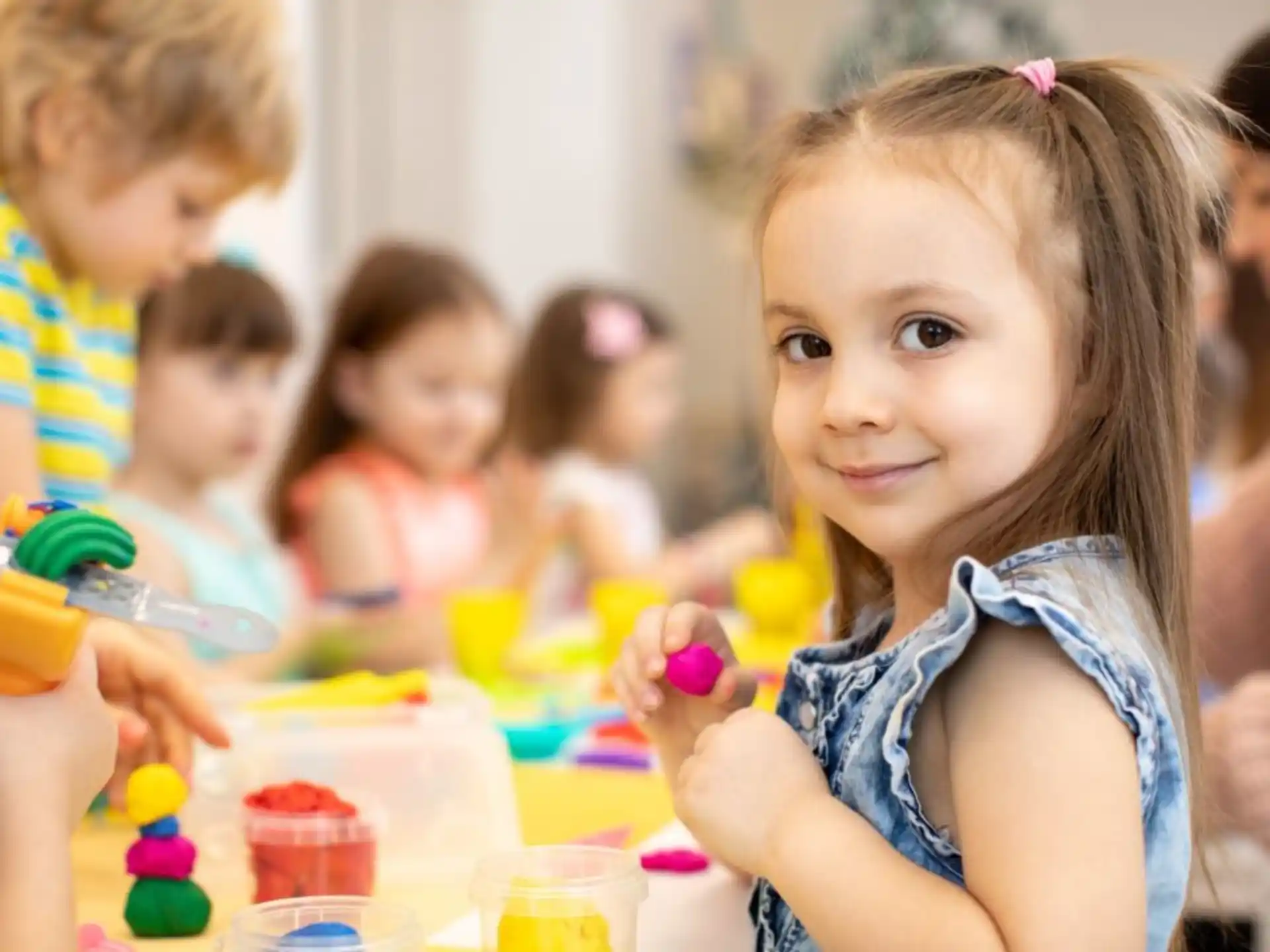a young girl holding a toy
