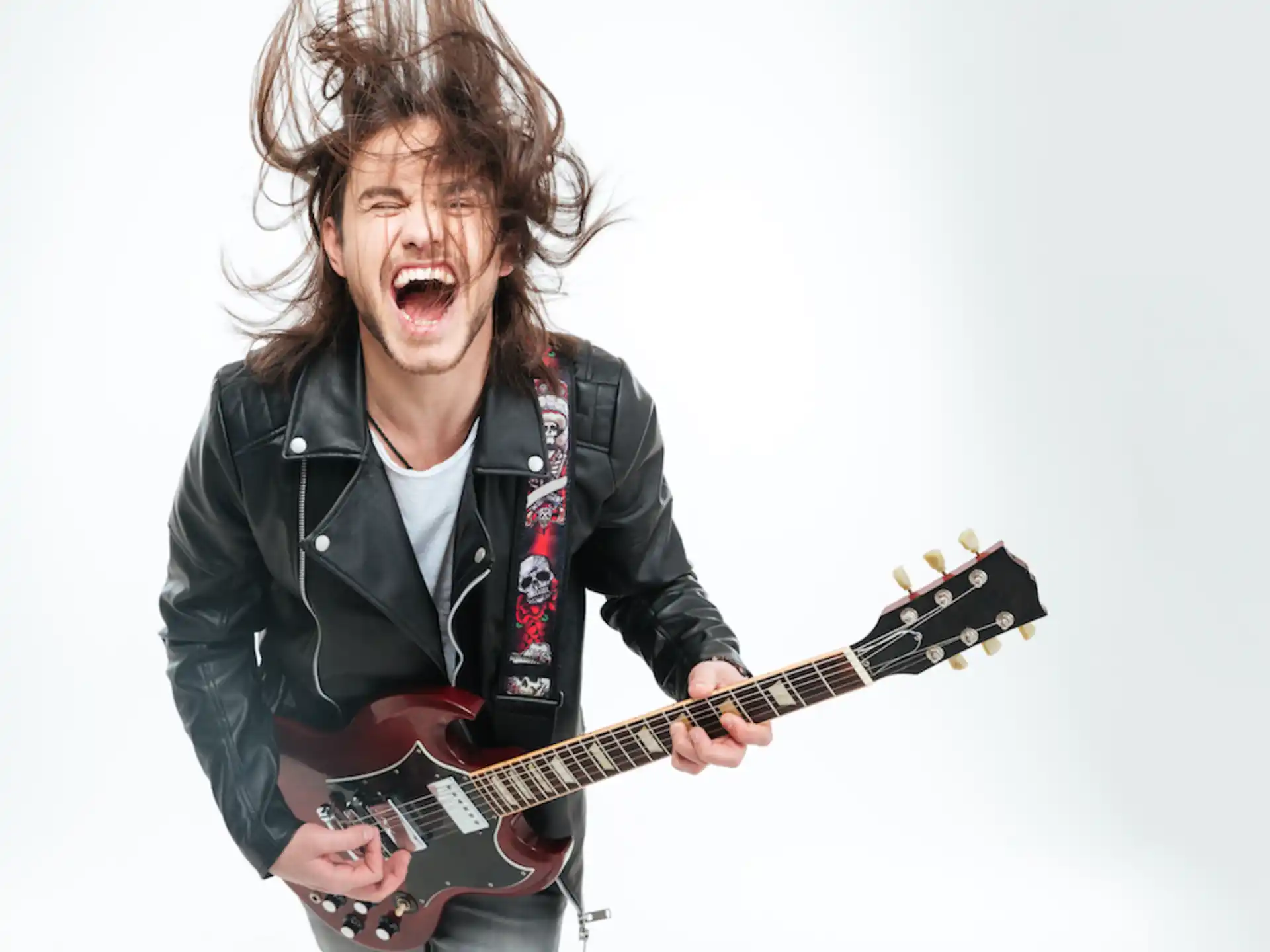 a person with long hair playing a guitar