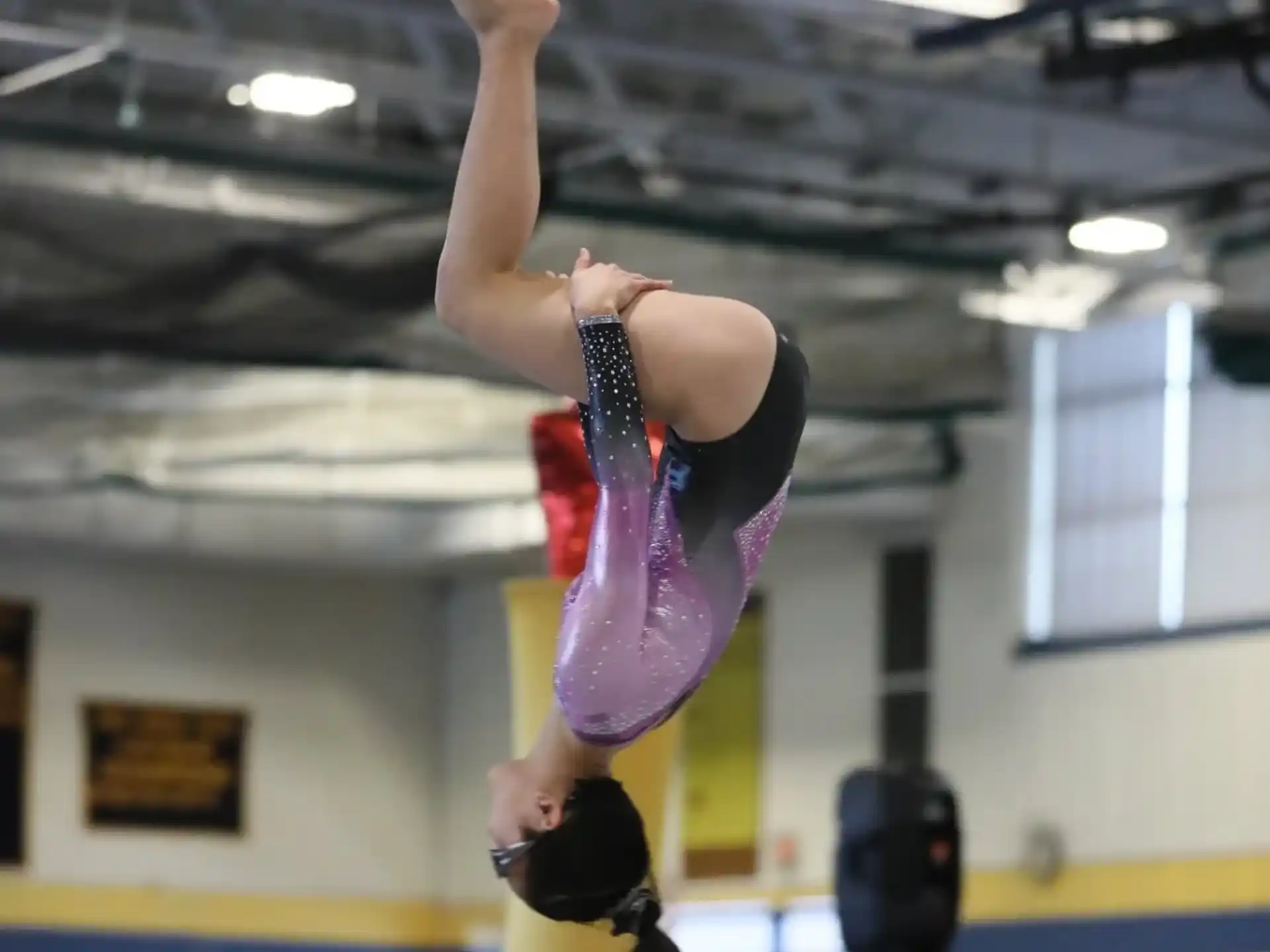 a woman doing a handstand