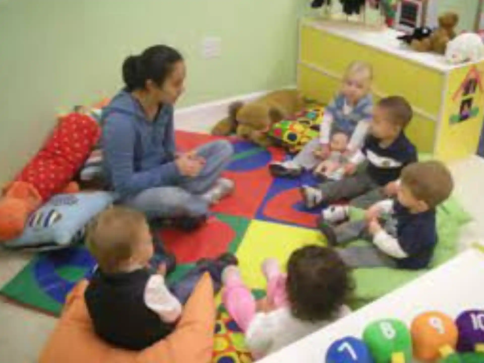 a person and several children sitting on the floor