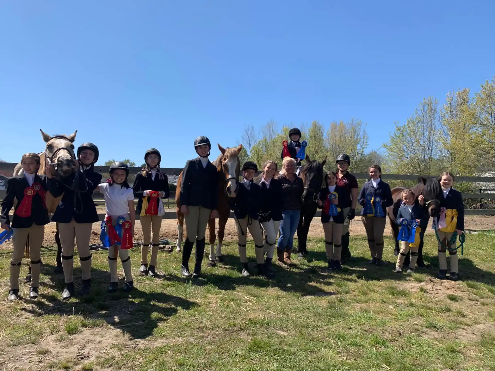 a group of people posing for a photo with a horse