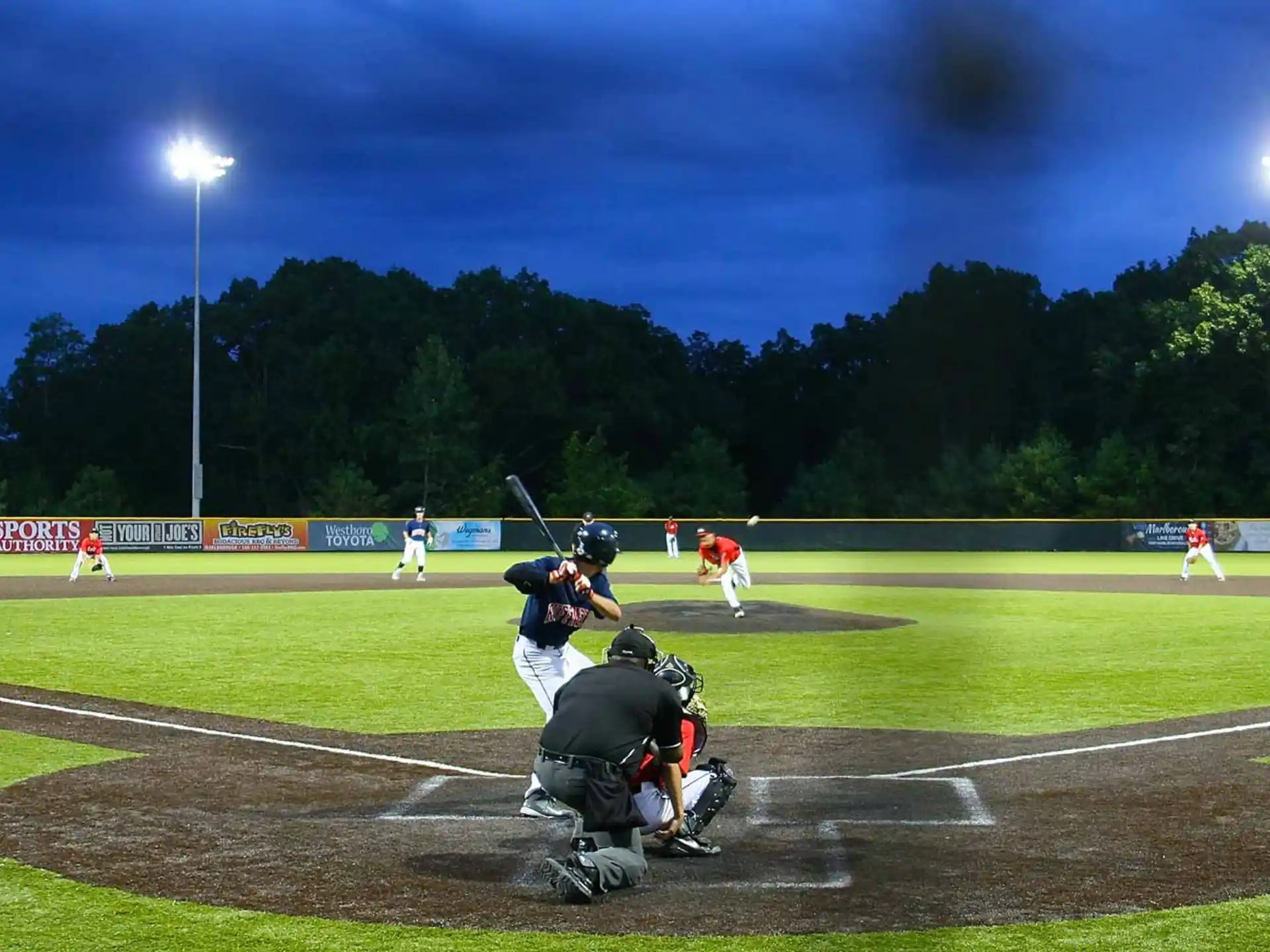 a baseball player prepares to swing a bat