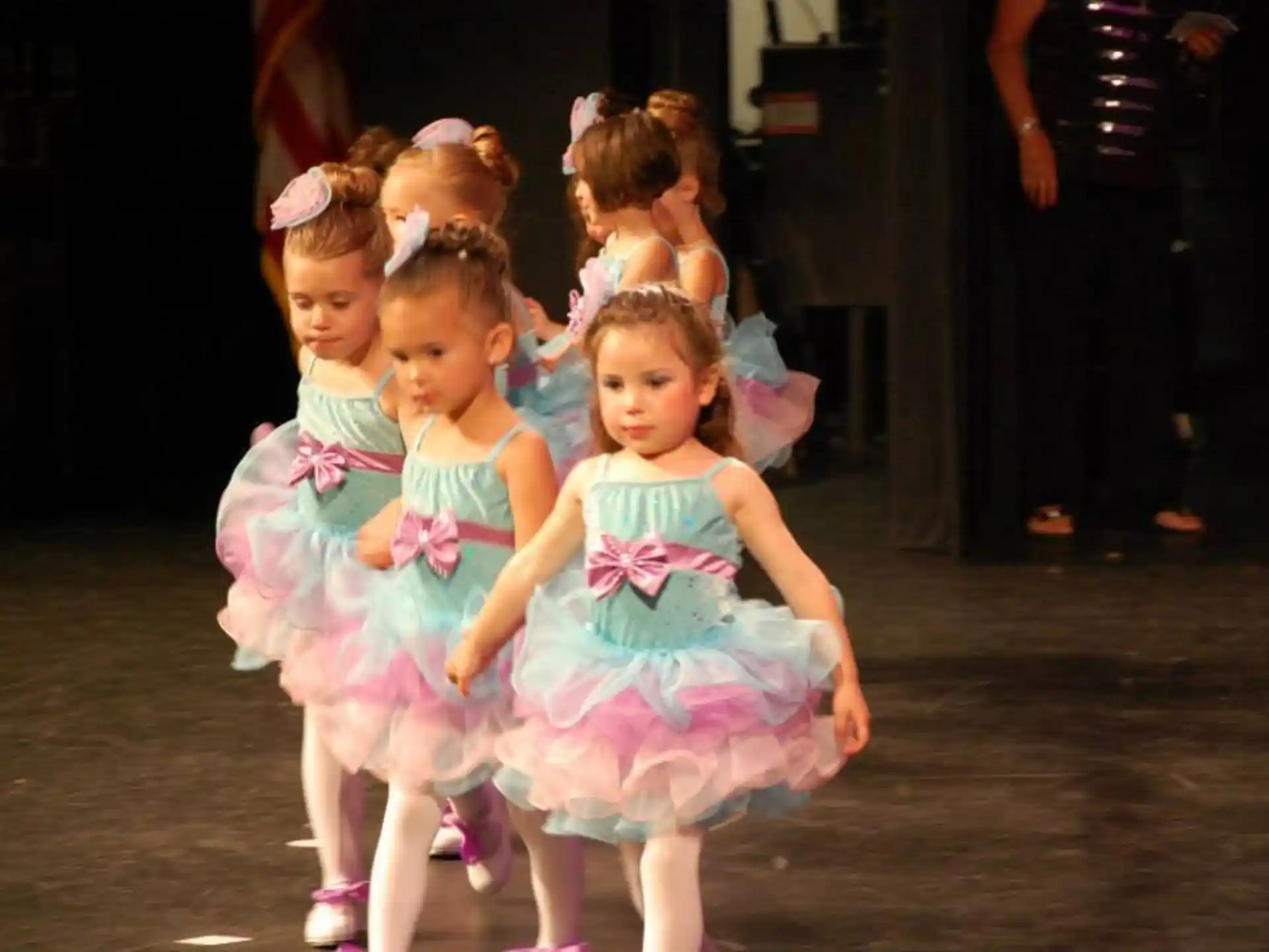a group of girls in dresses