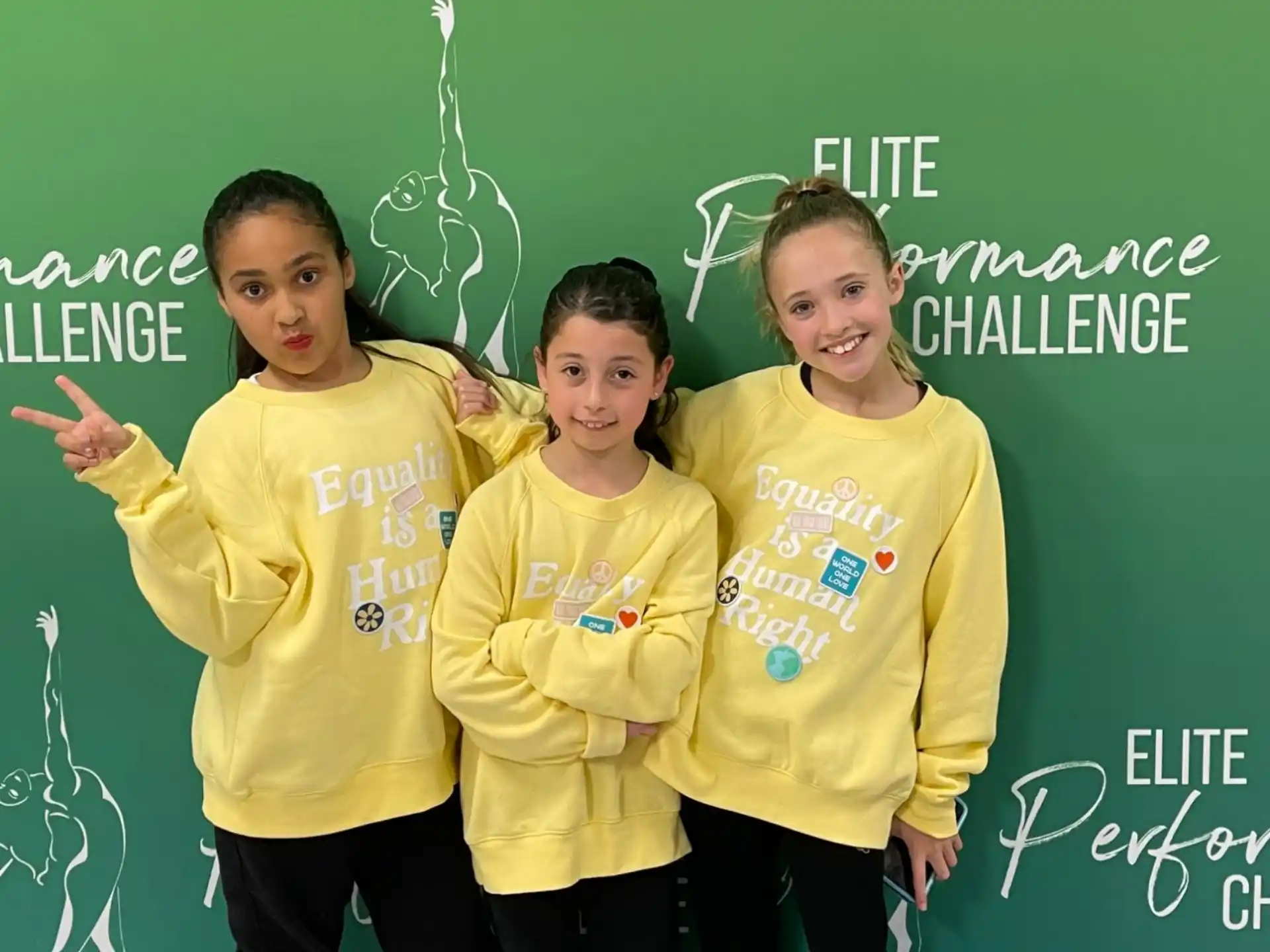 a group of girls in yellow shirts