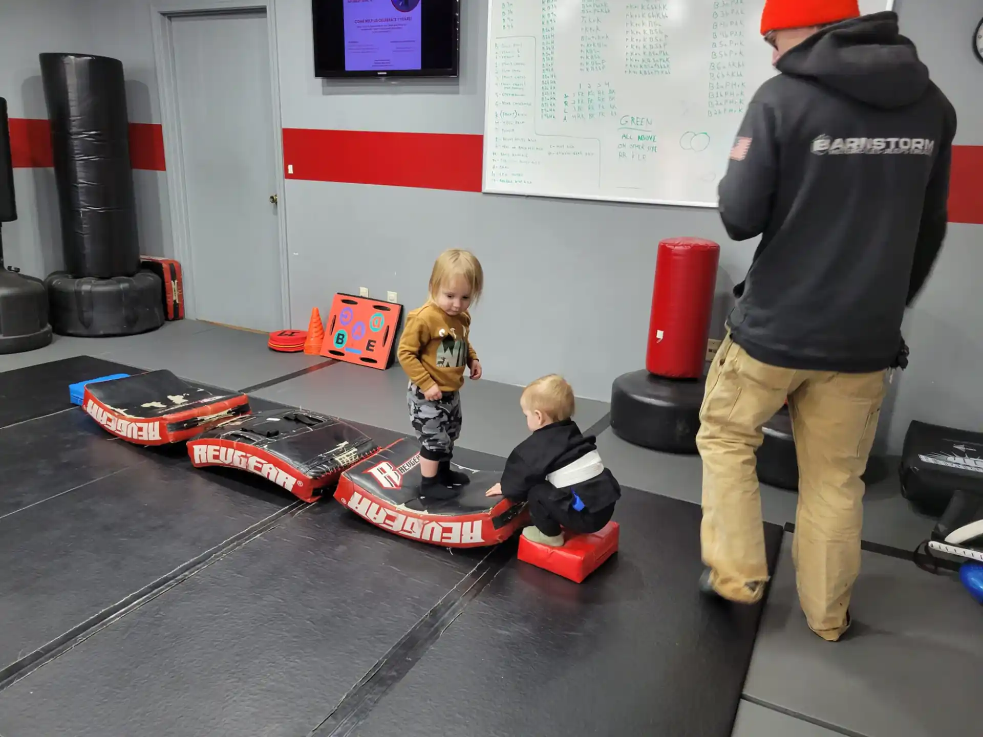 a person and a child on a table with toy cars