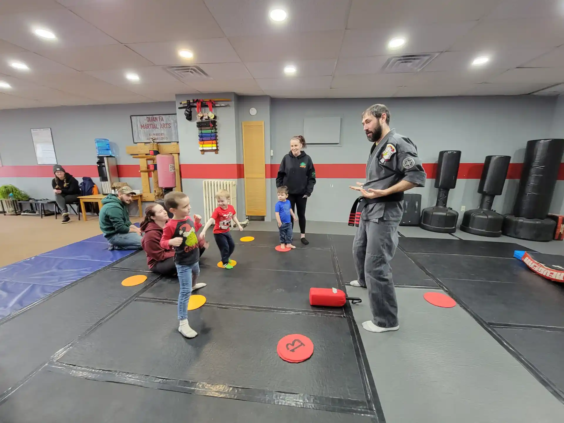 a person and a group of kids in a gym