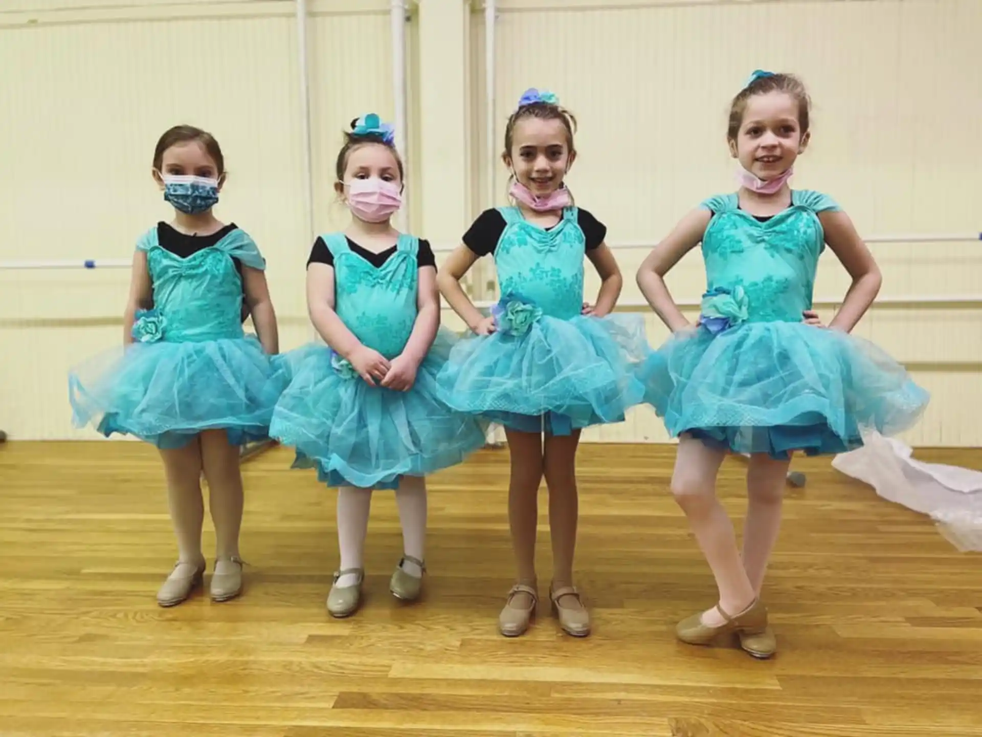 a group of girls in blue dresses